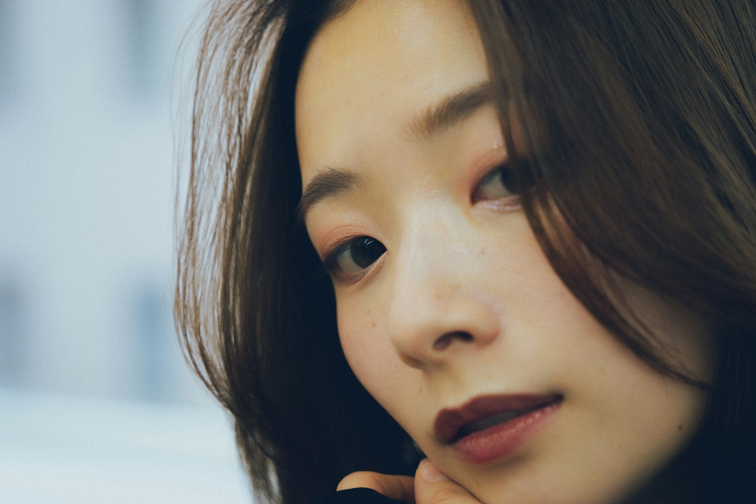 Portrait of a woman with long hair subtle makeup and a calm expression