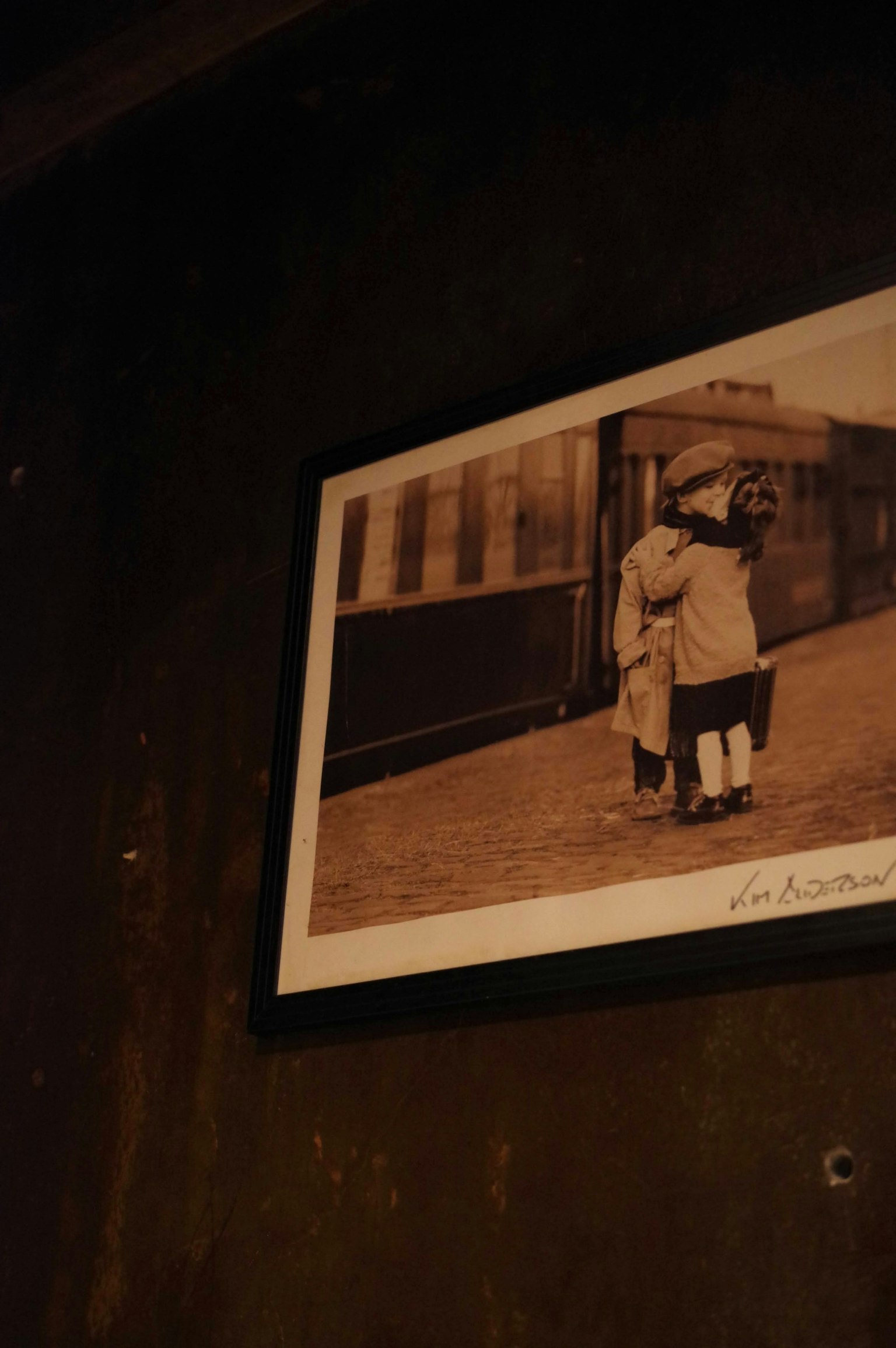 Old photograph of children standing in front of a train