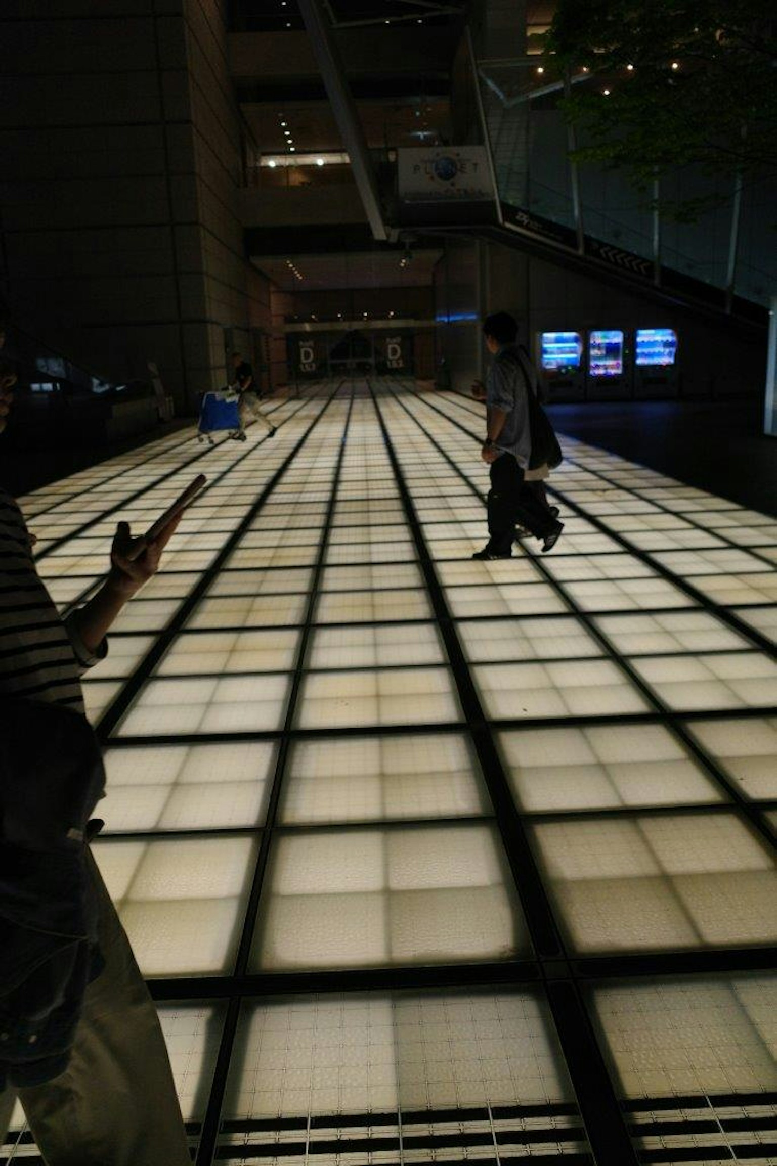 People walking on a bright tiled floor