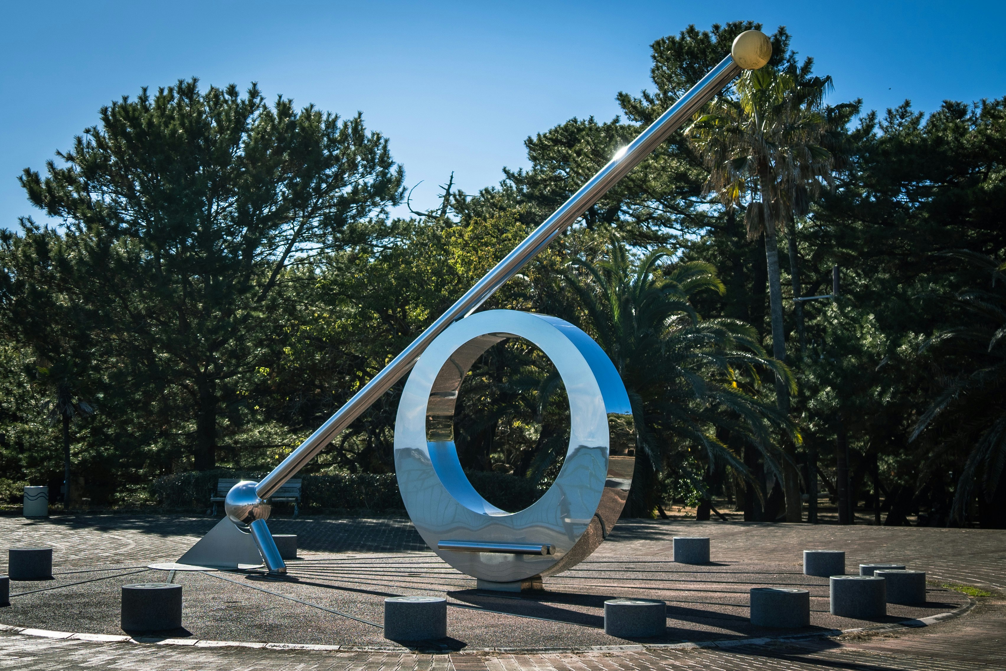 park plaza with a monument and blue circular sculpture