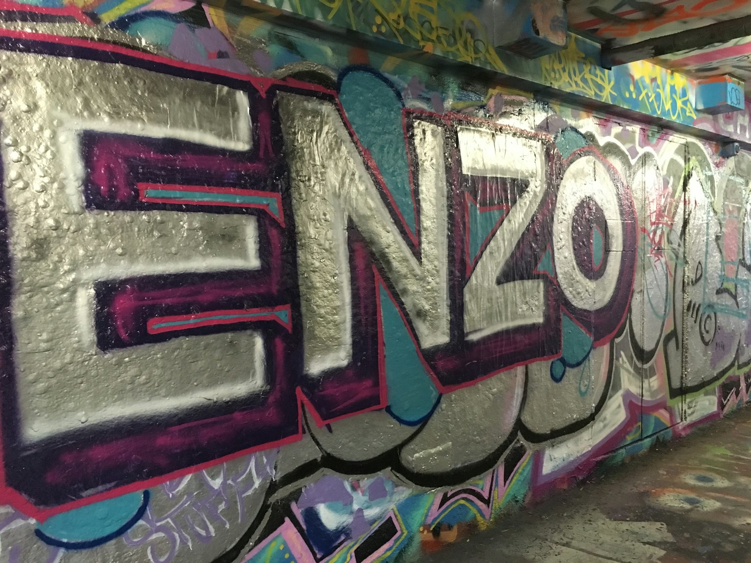 Colorful graffiti art featuring the name ENZO