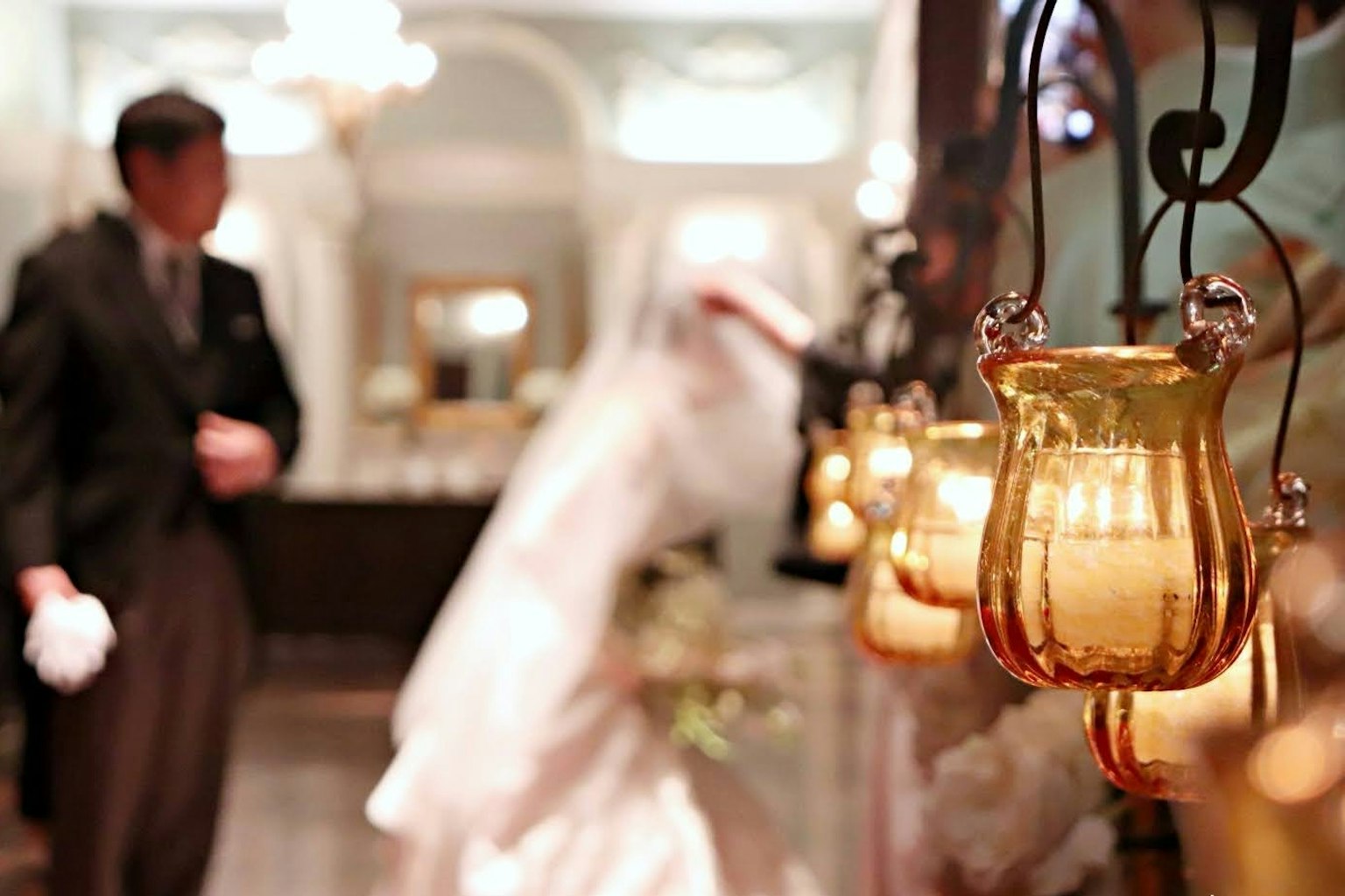A bride and groom gazing at each other in a decorated wedding venue