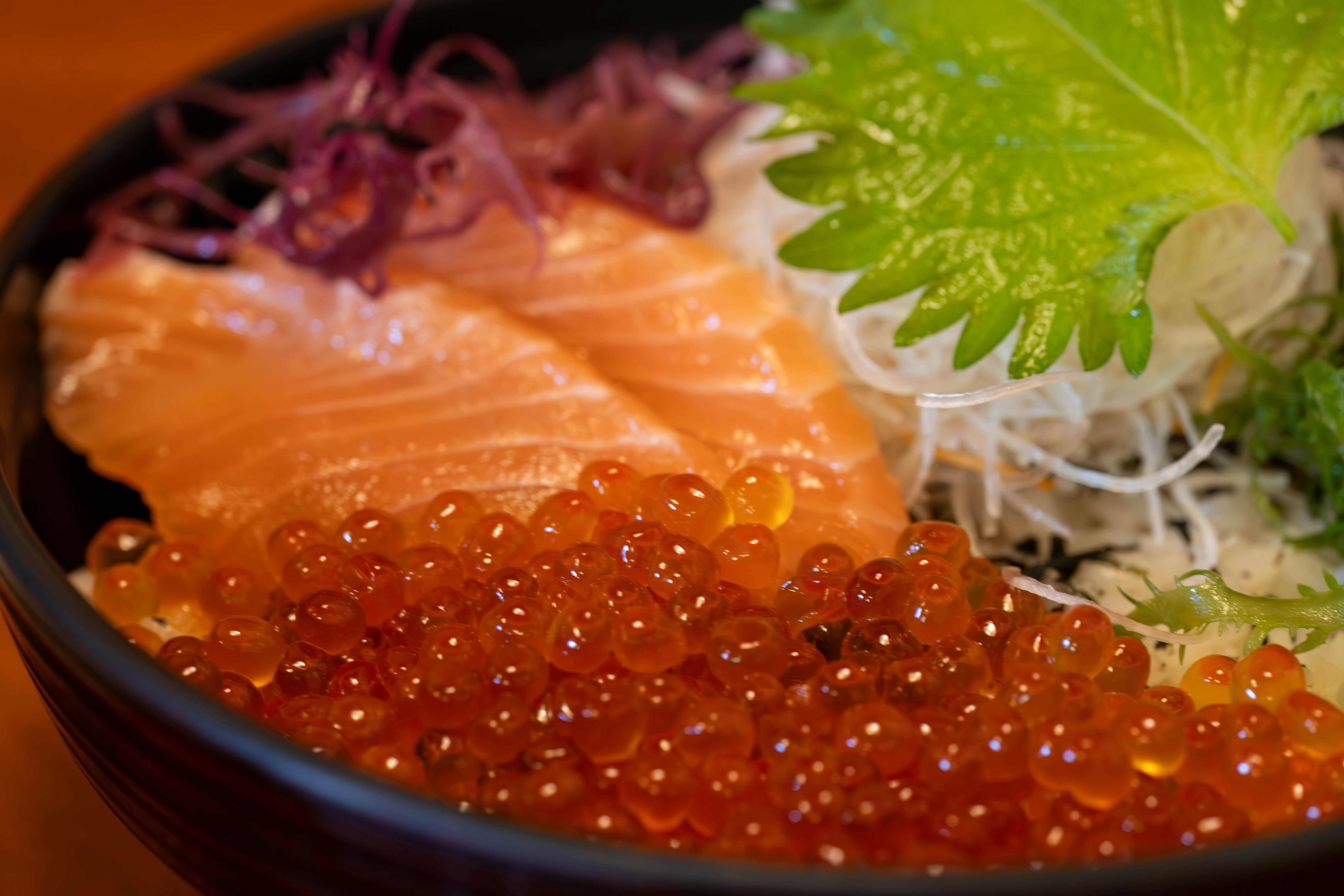 close-up of a seafood bowl with salmon and salmon roe