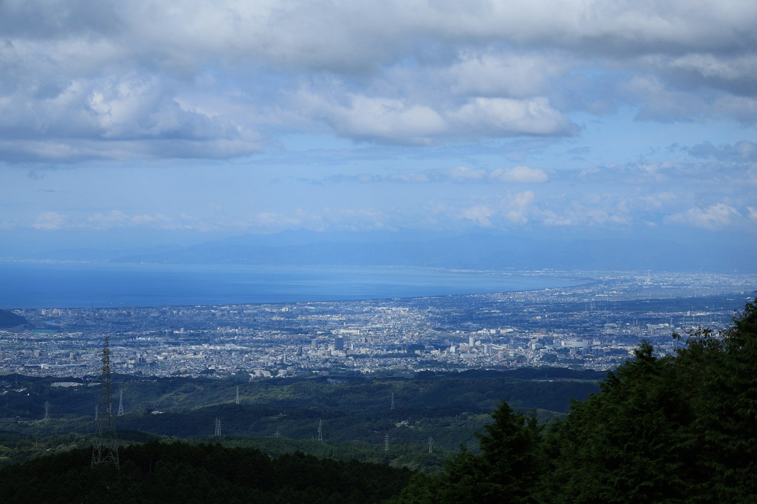Cityscape under blue sky with clouds