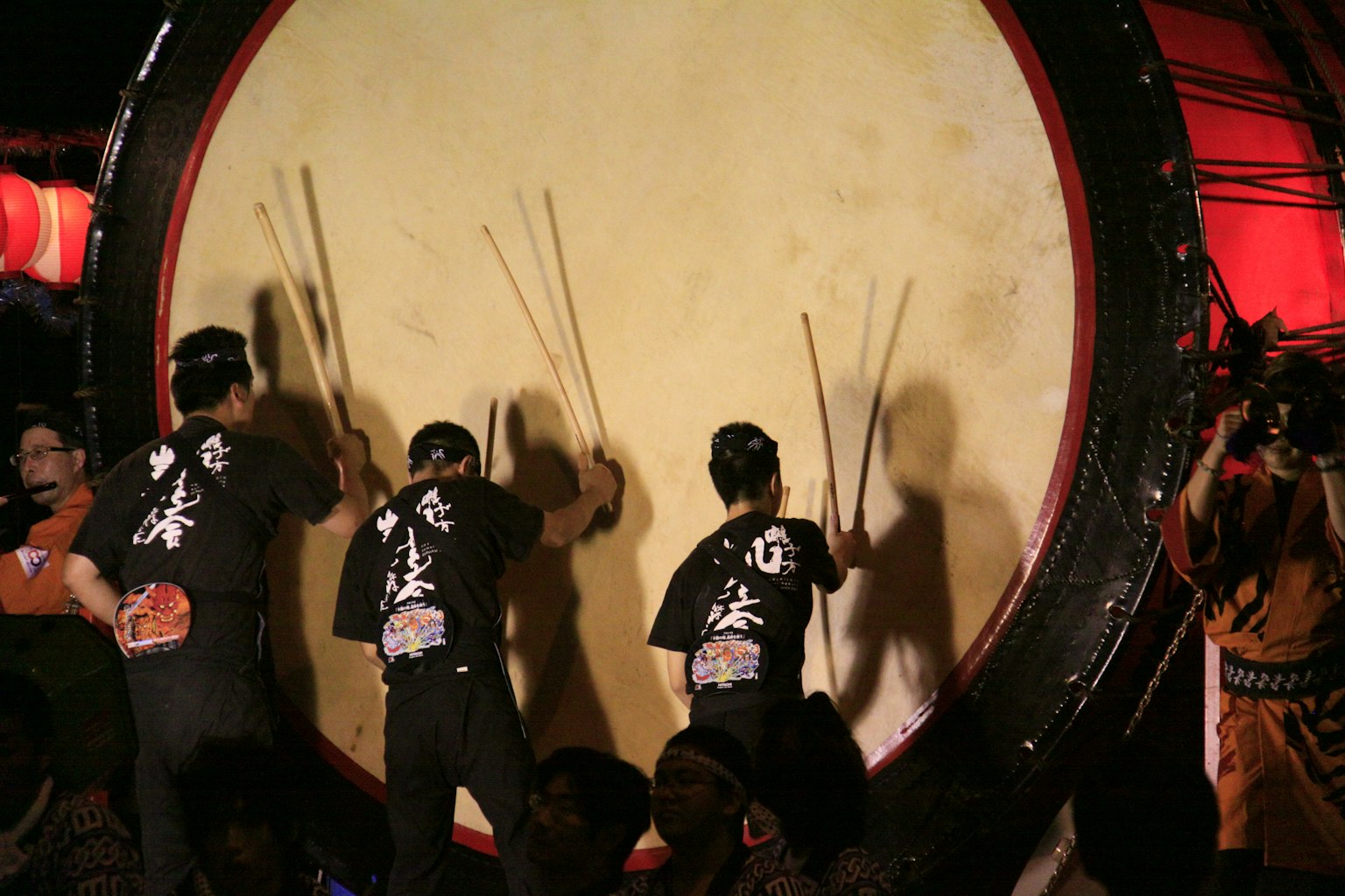 Uomini che suonano un grande tamburo taiko