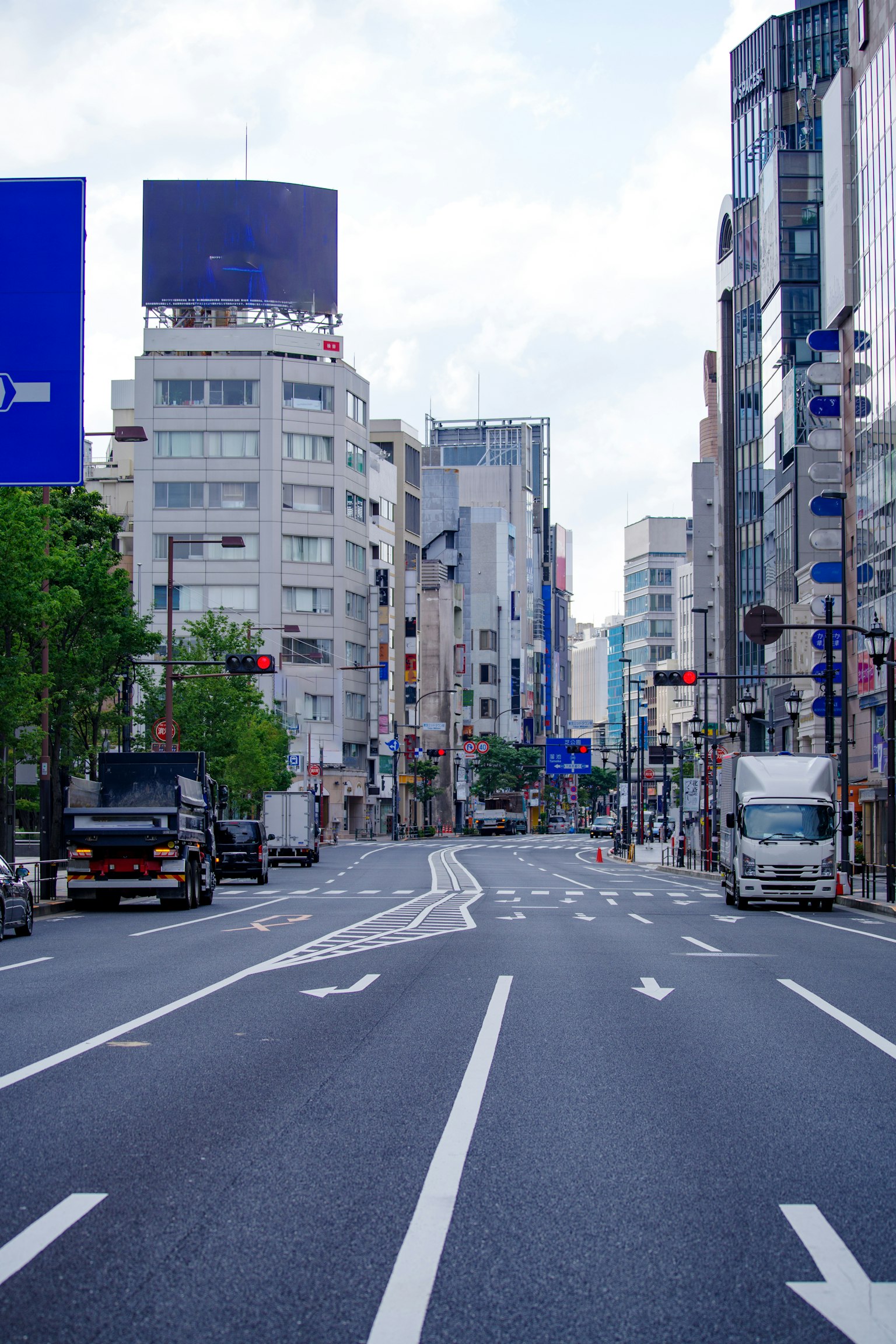 Quiet urban street with tall buildings and clear sky