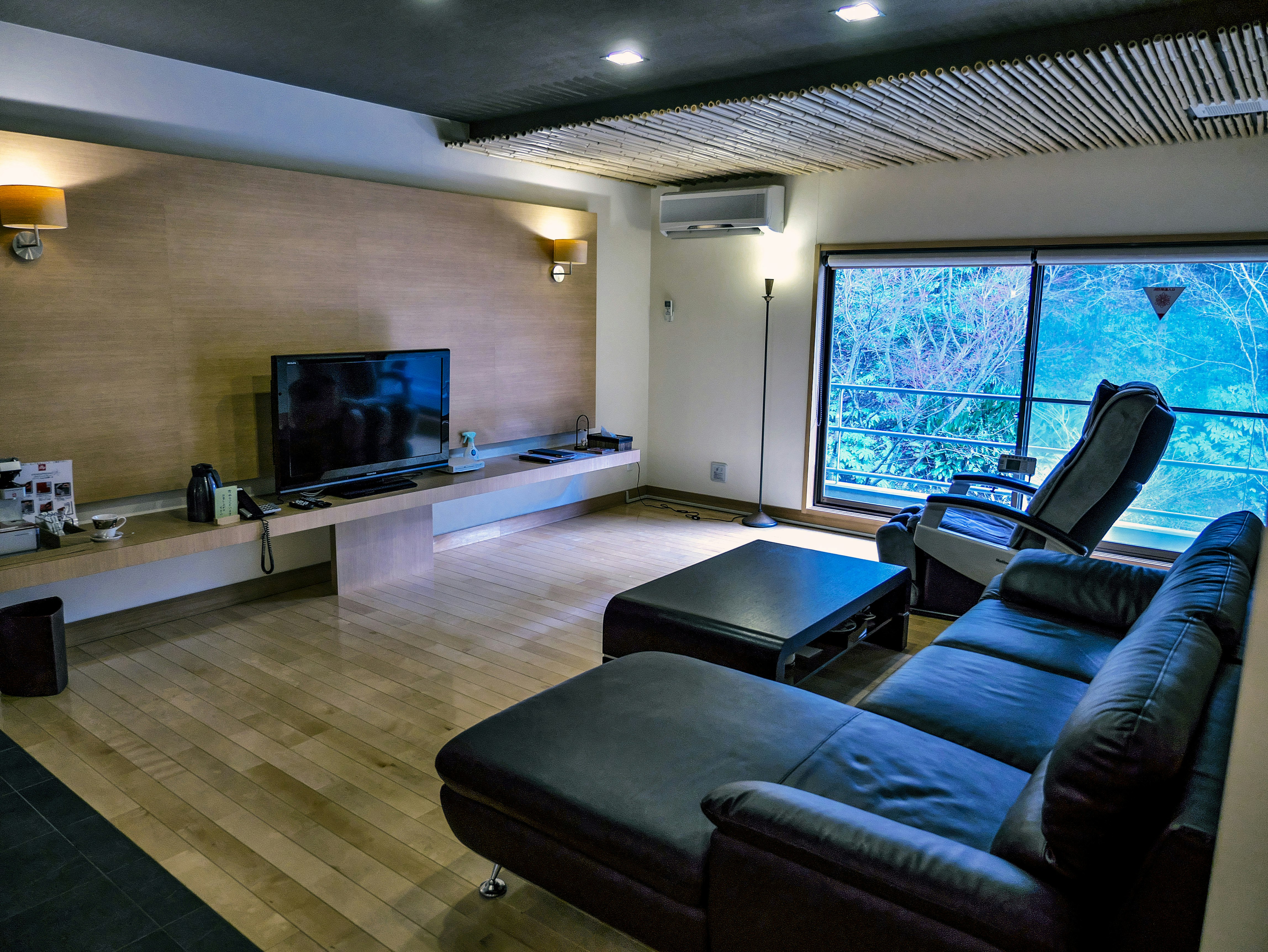 modern living room with sofa and coffee table by a large window
