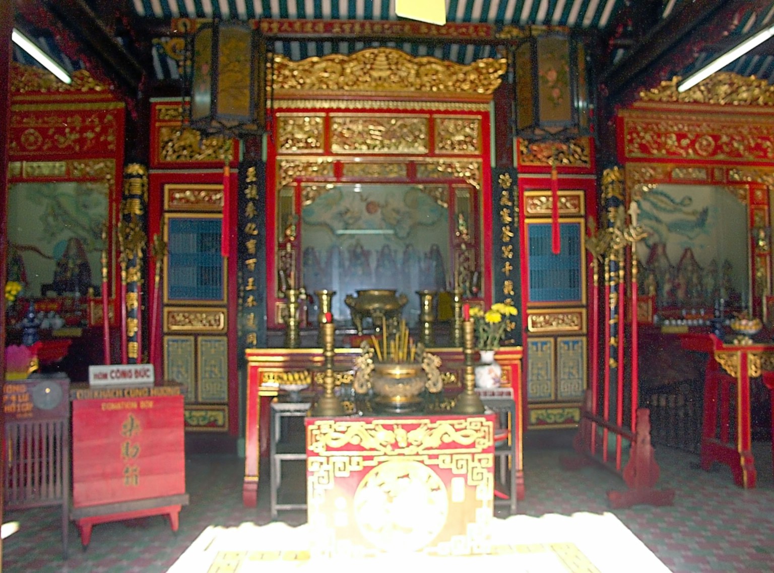 Interior of a traditional temple with red decorations and an altar