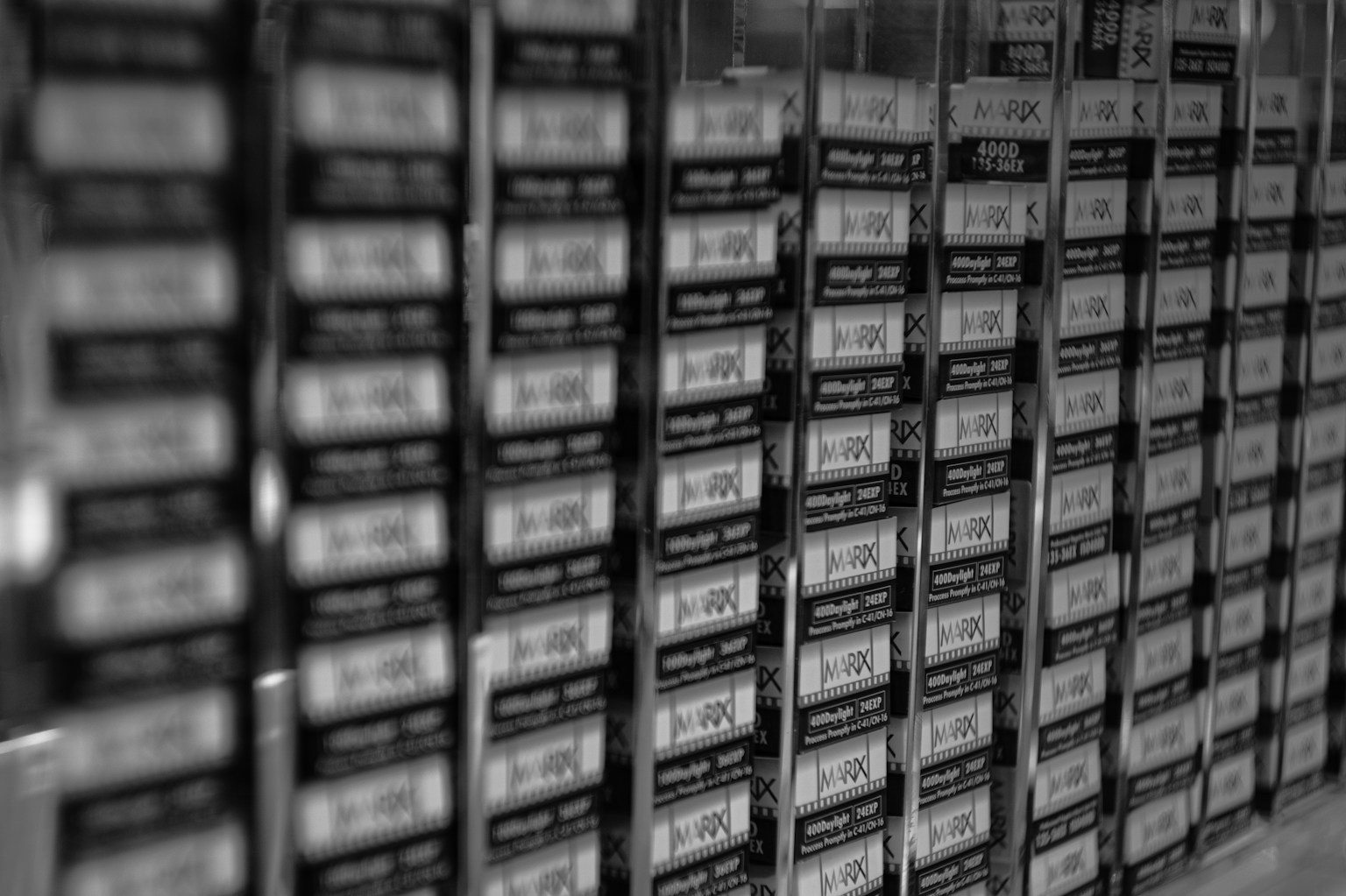 A row of black and white film boxes neatly arranged