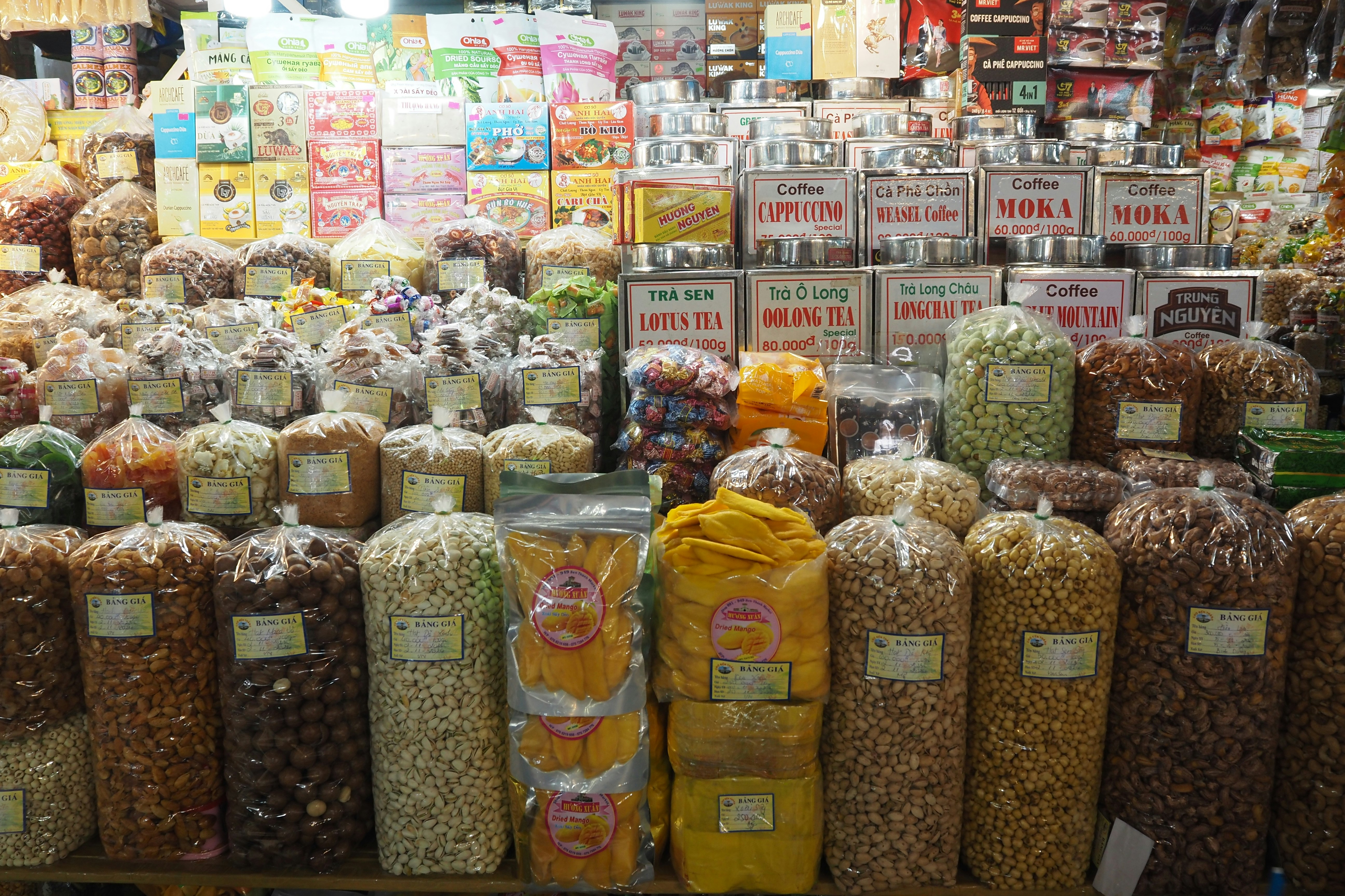 bags of grains and beans lined up on a grocery shelf