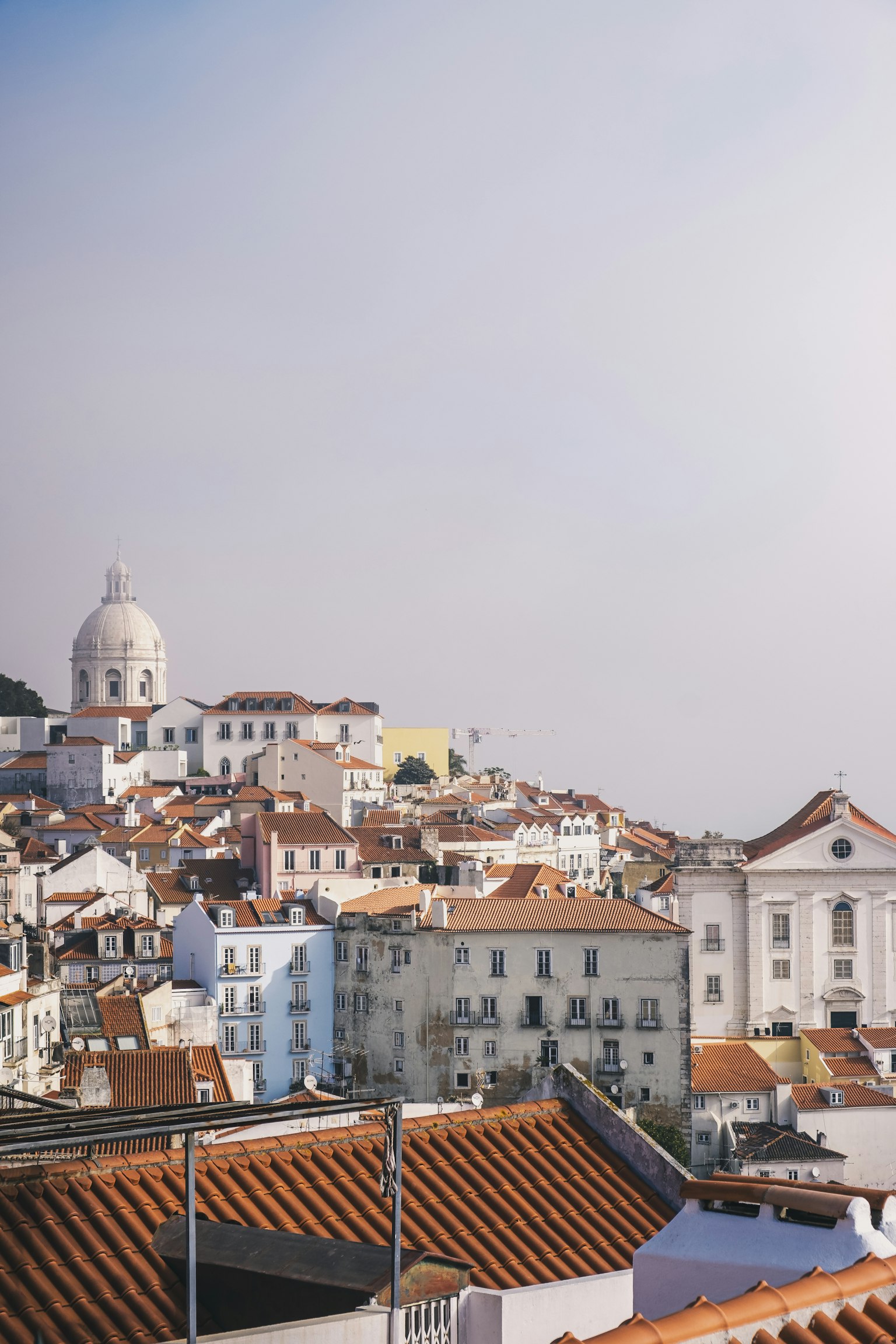 Panoramic view of Lisbon with white buildings and orange rooftops