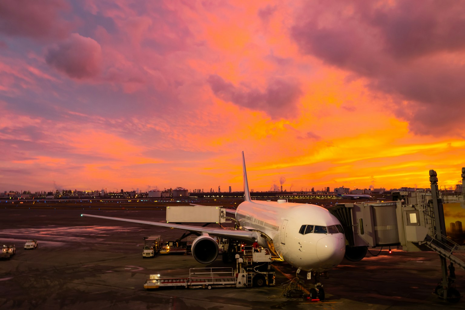 Passenger plane at the airport with a vibrant sunset sky