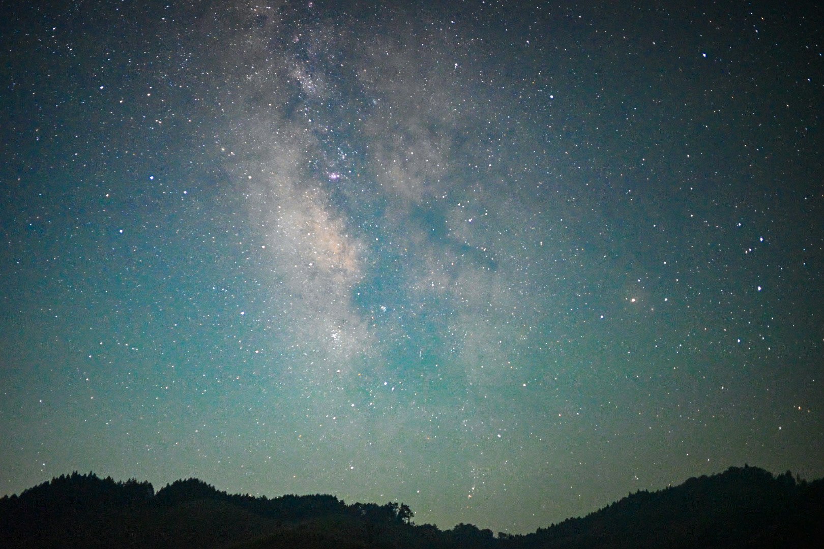 Via Lattea sopra le creste montuose di notte