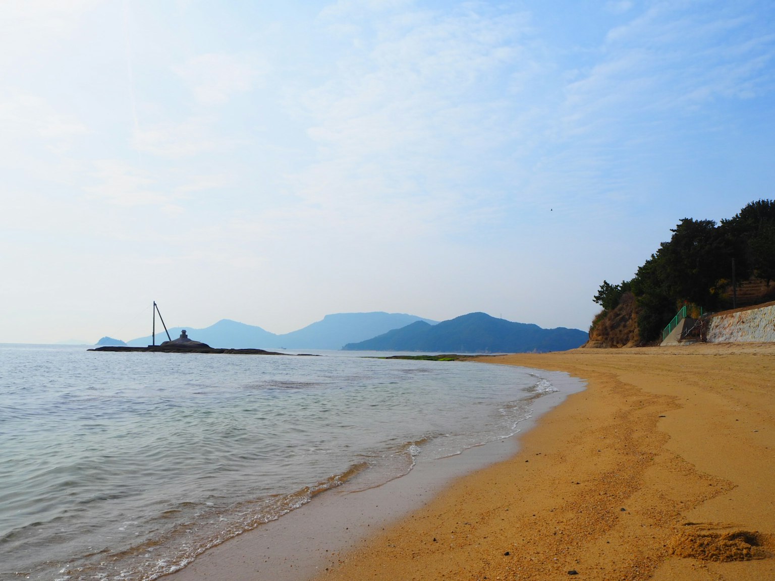 Beach landscape with calm sea and blue sky