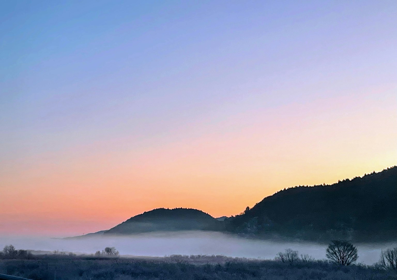 Misty mountains with soft sunrise colors