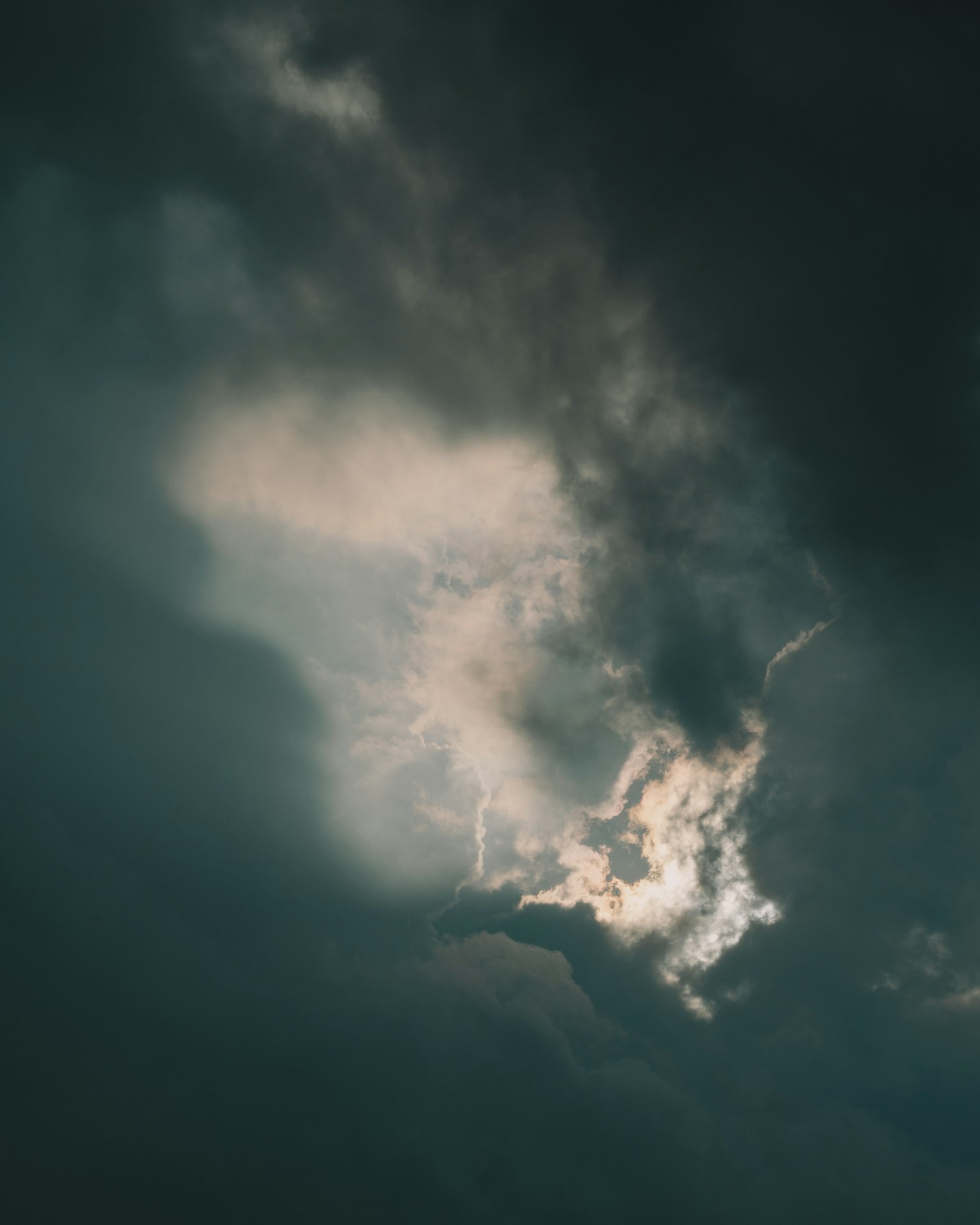 Cielo misterioso con luce che penetra attraverso nuvole scure
