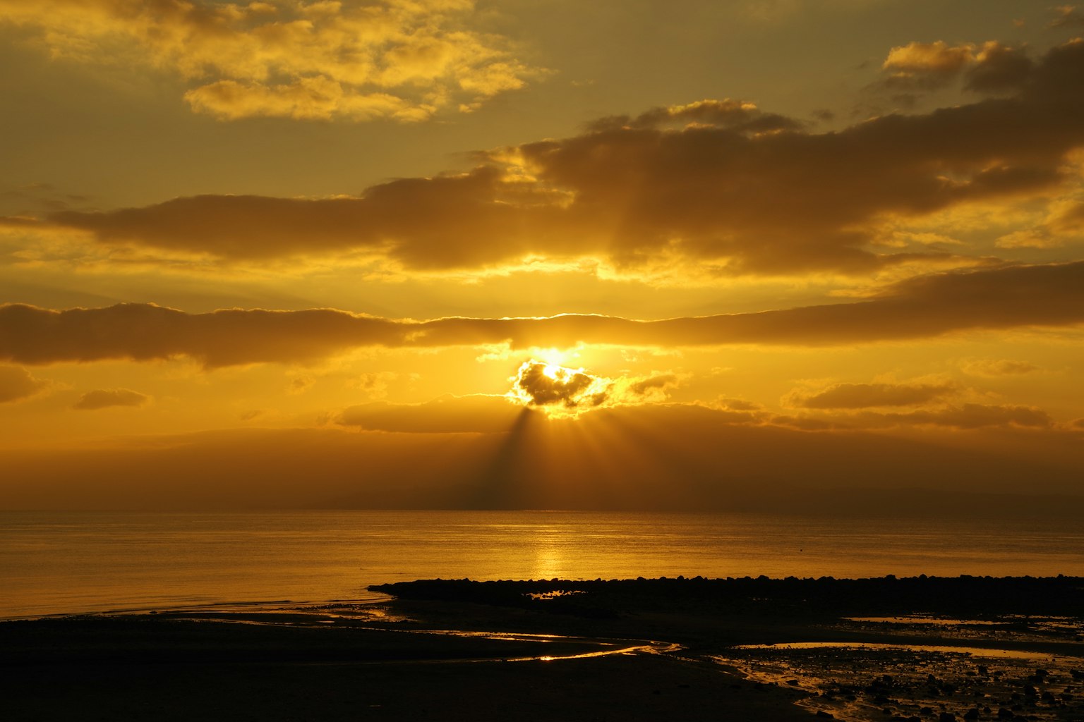A beautiful sunset over the sea clouds illuminated by golden light