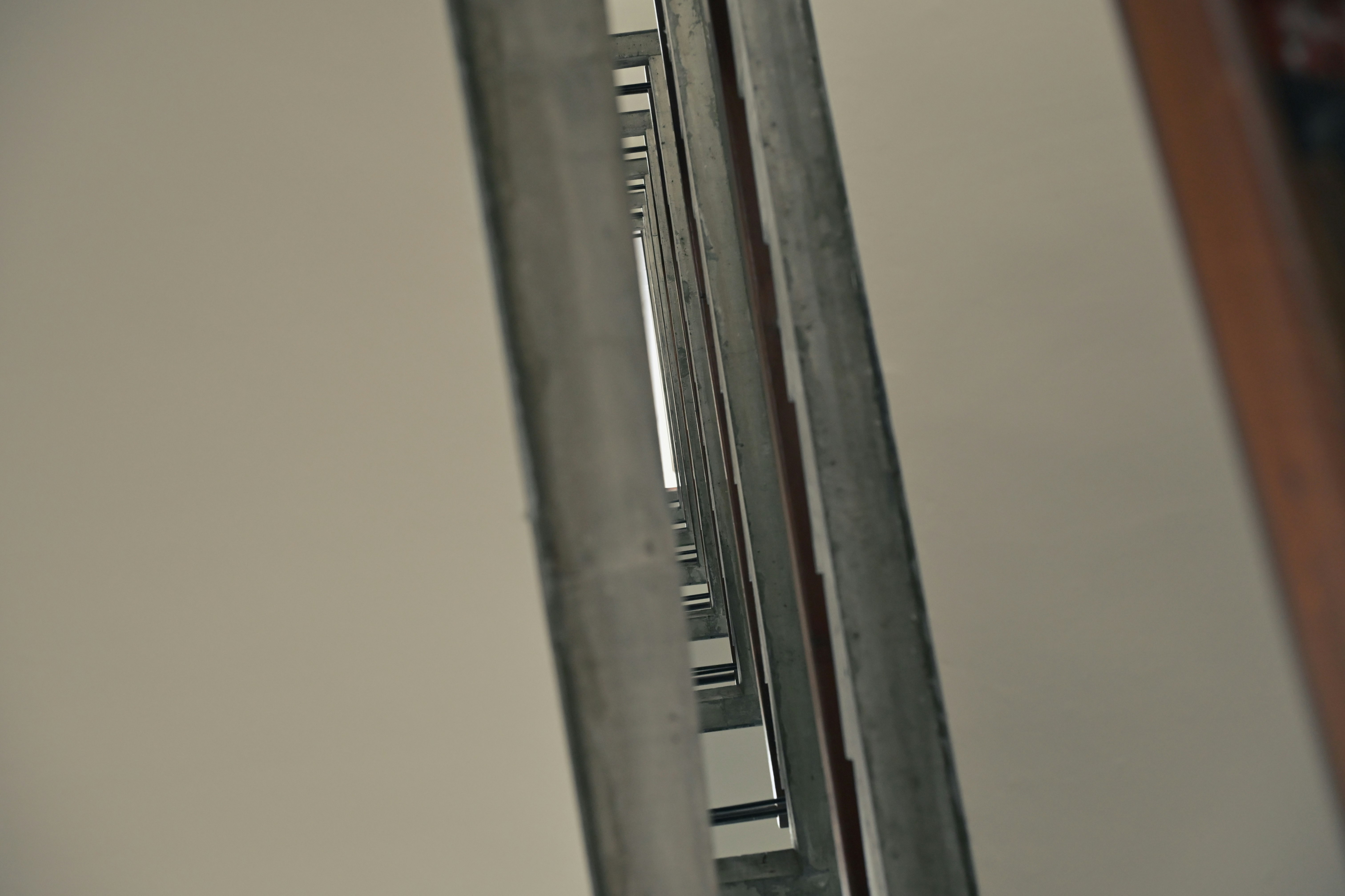 narrow corridor with metal shelving and wall gaps