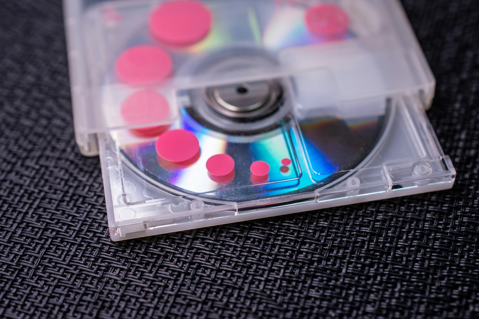 CD in a transparent case with colorful dots