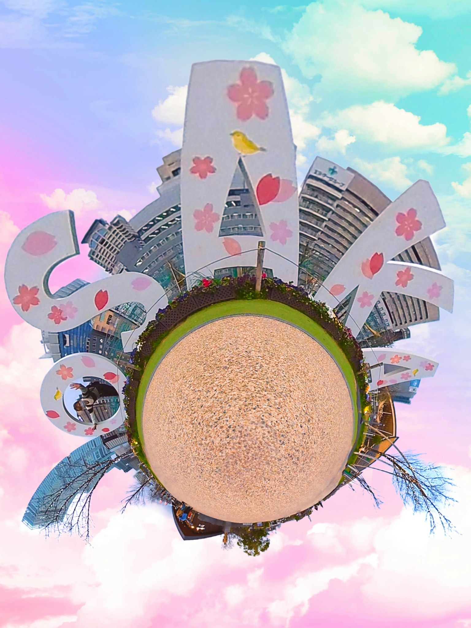 Landscape featuring large signs with cherry blossom designs and surrounding buildings under a pastel-colored sky