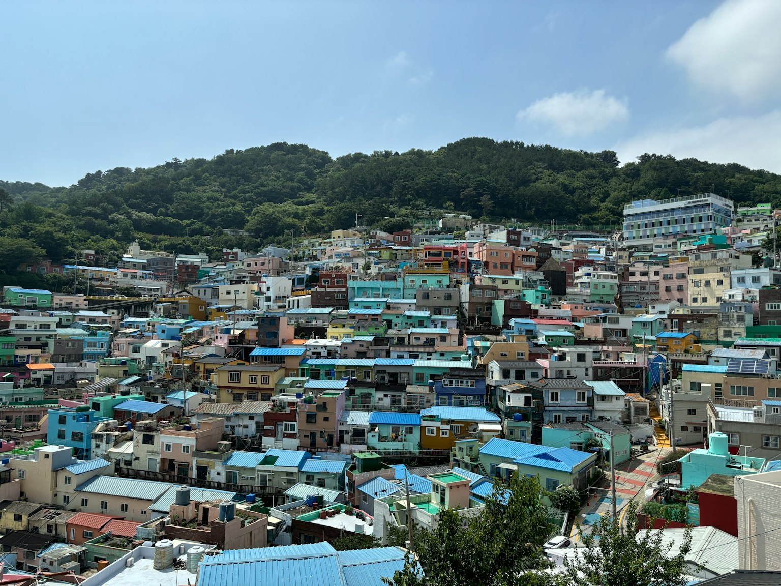 Colorful houses spread across a hillside landscape