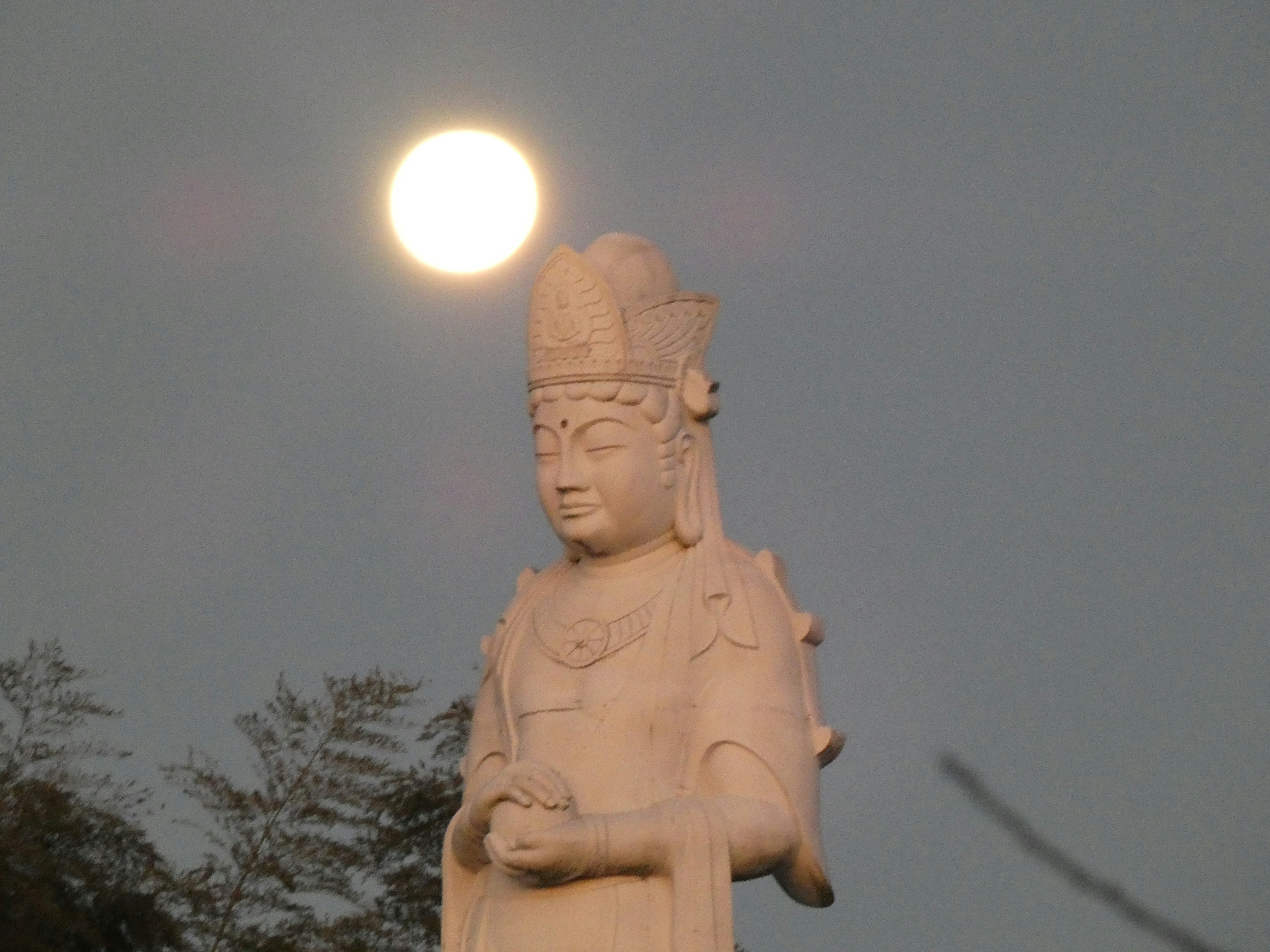 Buddha statue standing against the sky