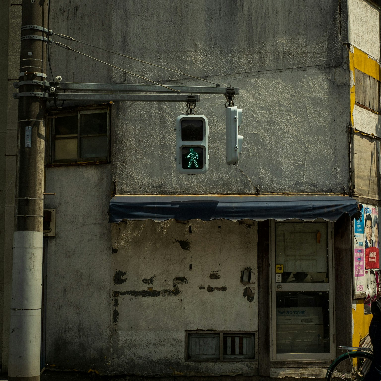 An old building with a prominent pedestrian signal on the wall