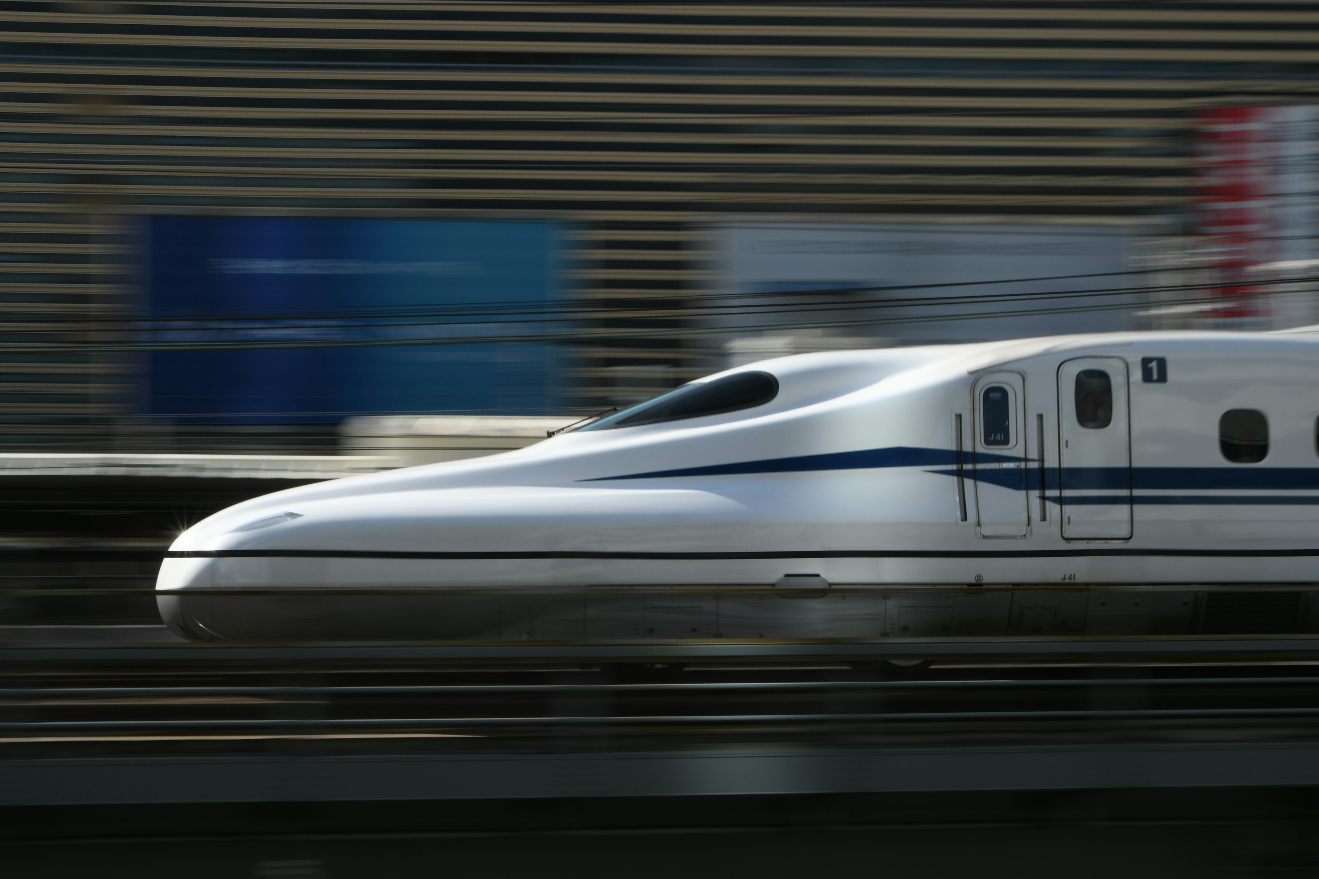 white high-speed train speeding past