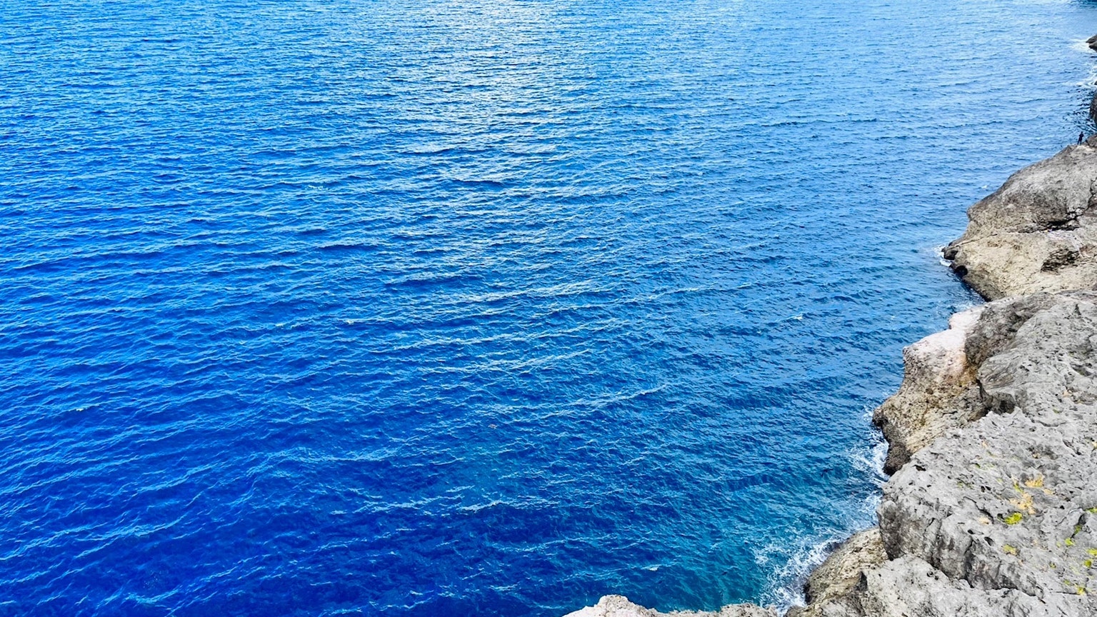 Scenic view of blue ocean and rocky cliff