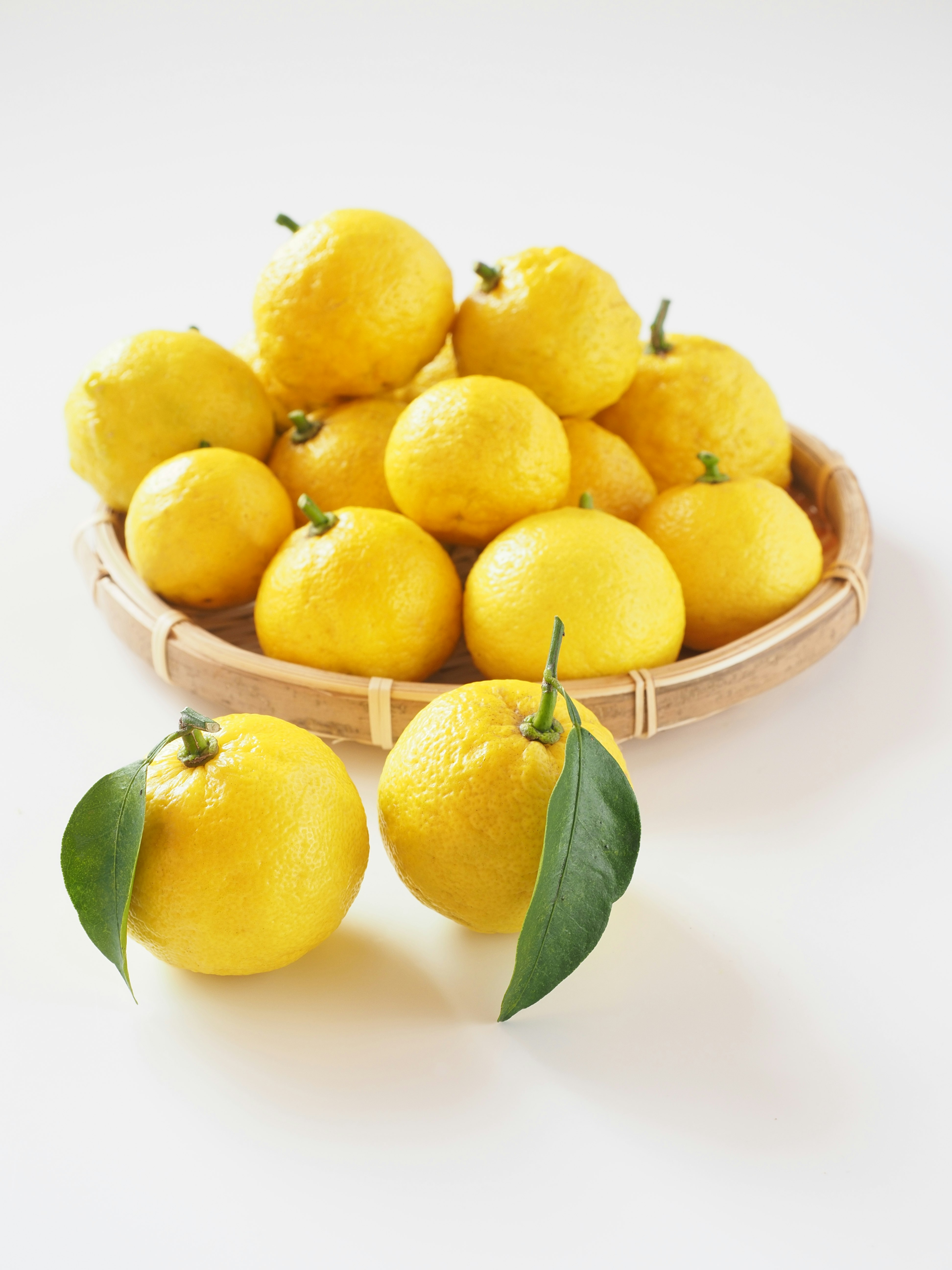 still life of lemons in a wooden tray