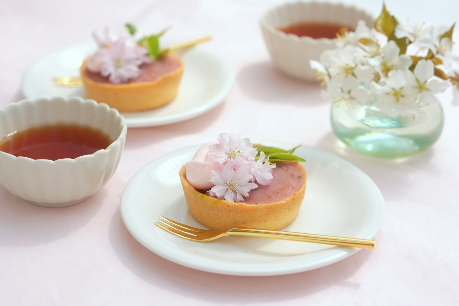 Postre con flores de cerezo y juego de té