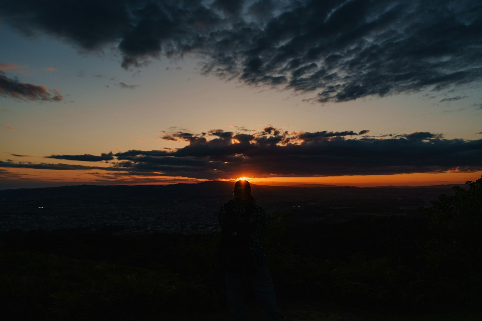 Silhouette of a couple against a stunning sunset landscape