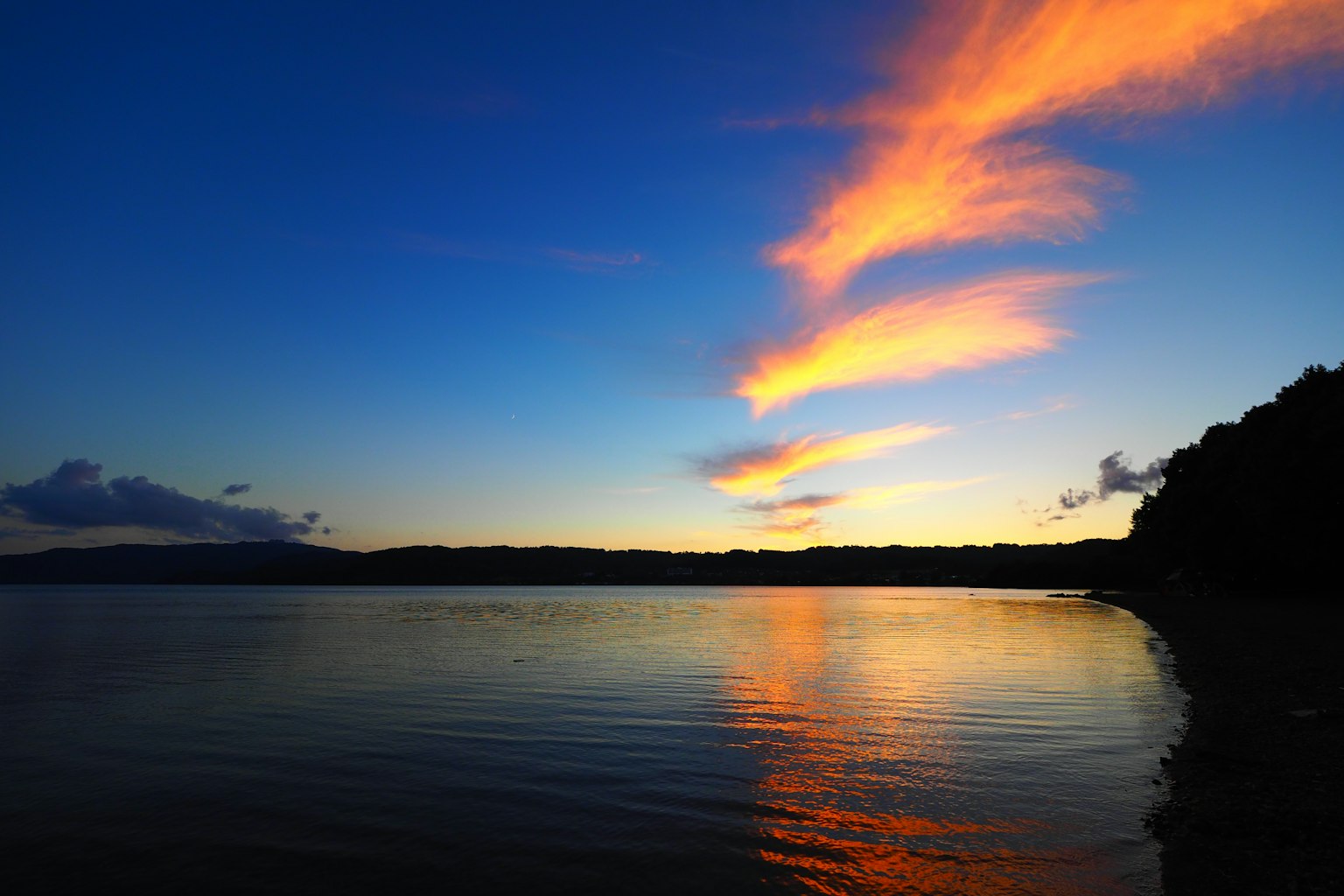 Beautiful orange clouds reflecting on the water at sunset