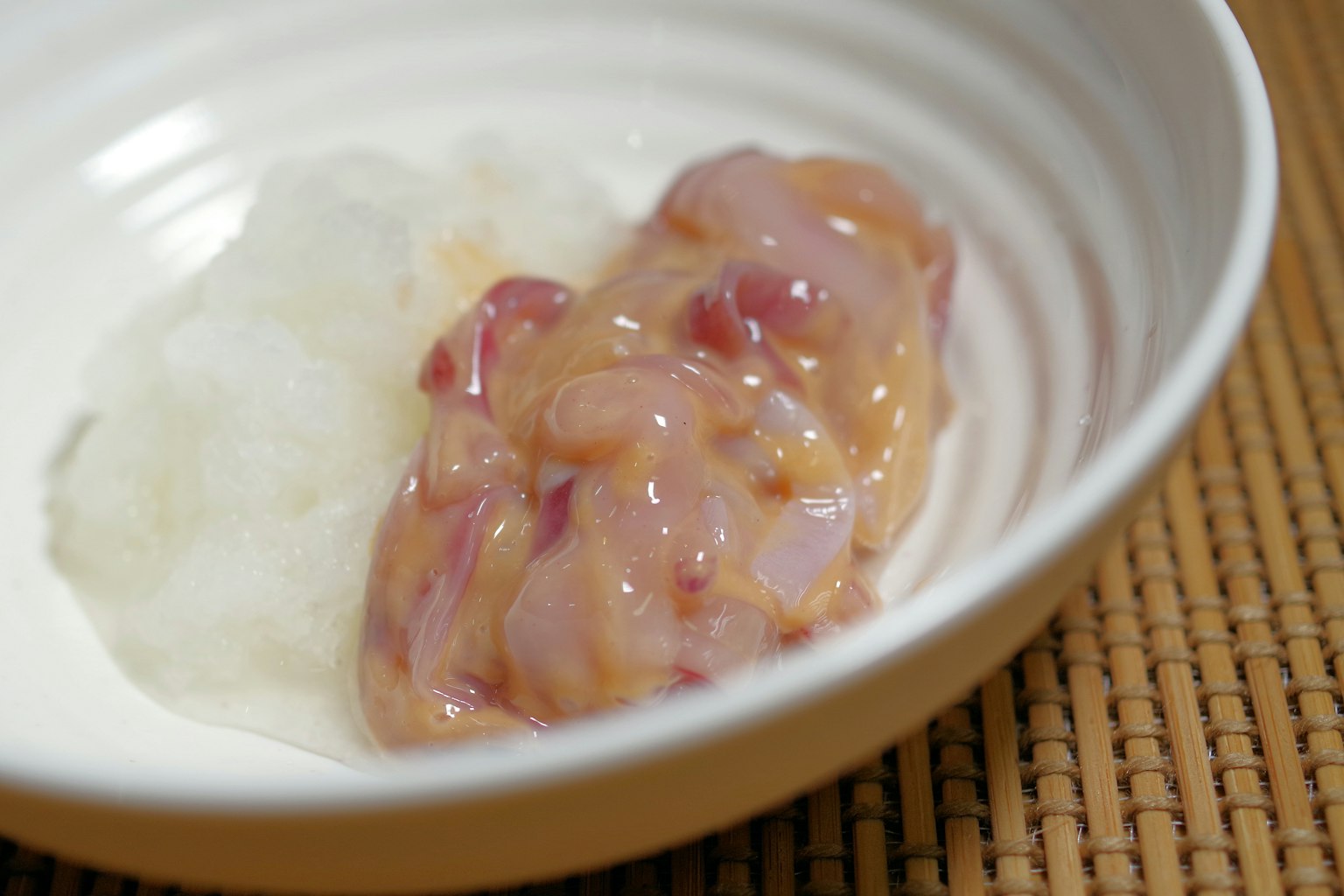 Raw fish fillet served with rice in a white bowl