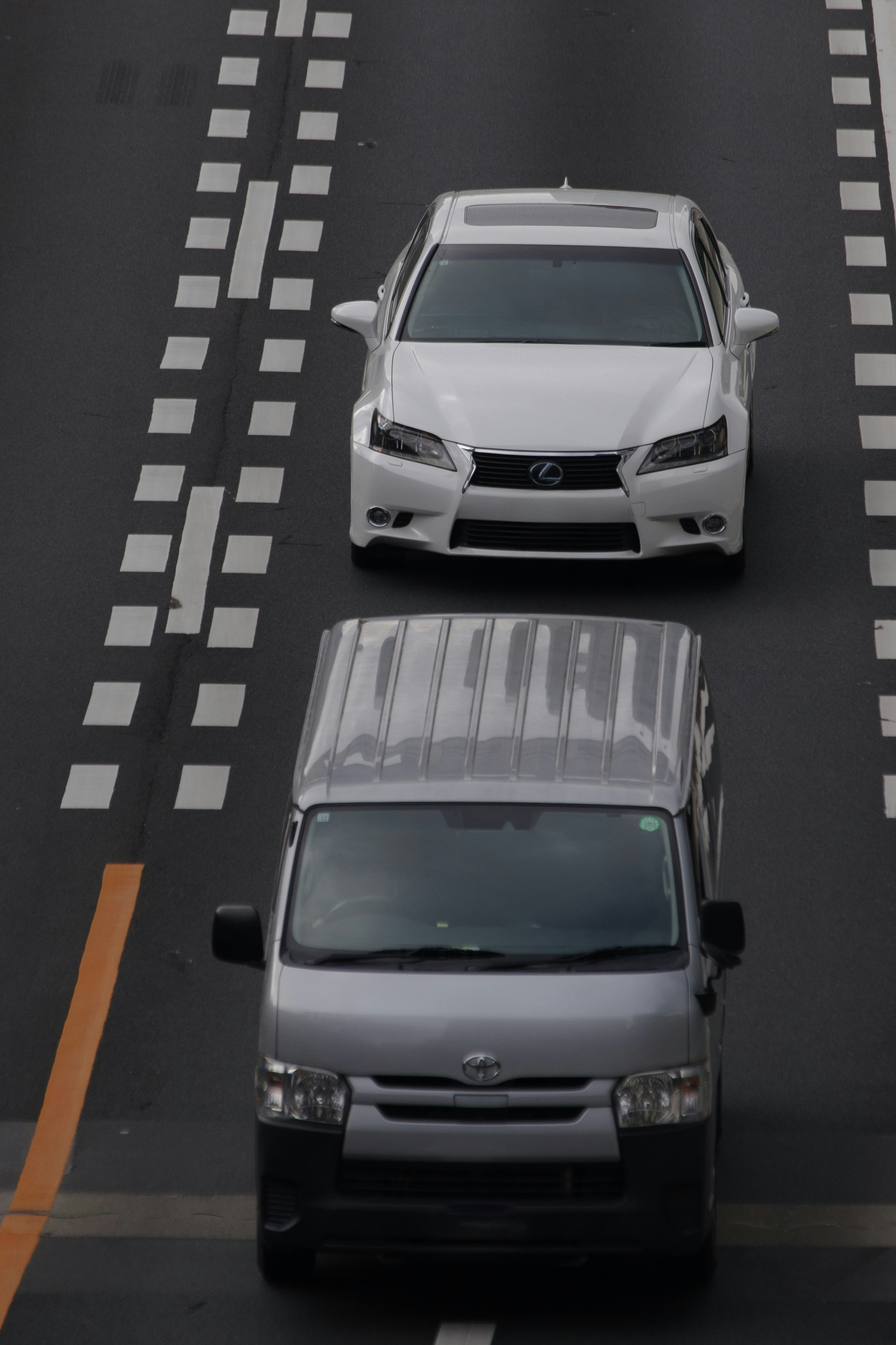 Lexus and Toyota cars driving on a road
