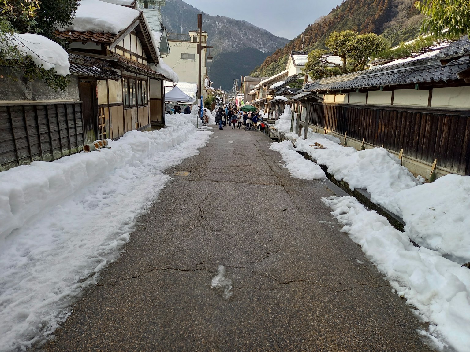 Jalan bersalju dengan rumah tradisional Jepang