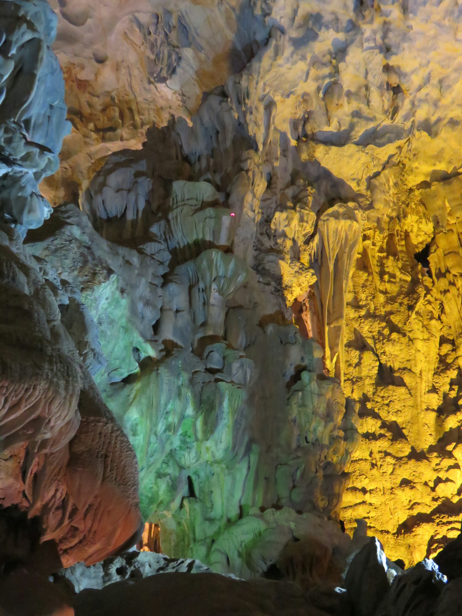Image of a cave interior illuminated with colorful lighting