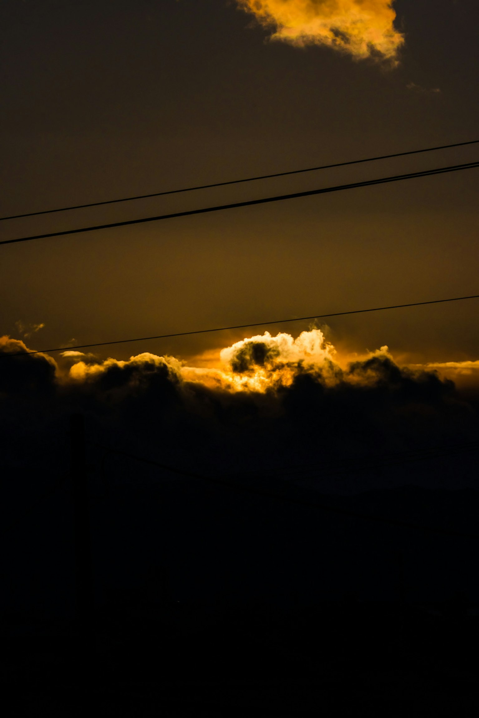 Dark clouds illuminated by orange light during twilight