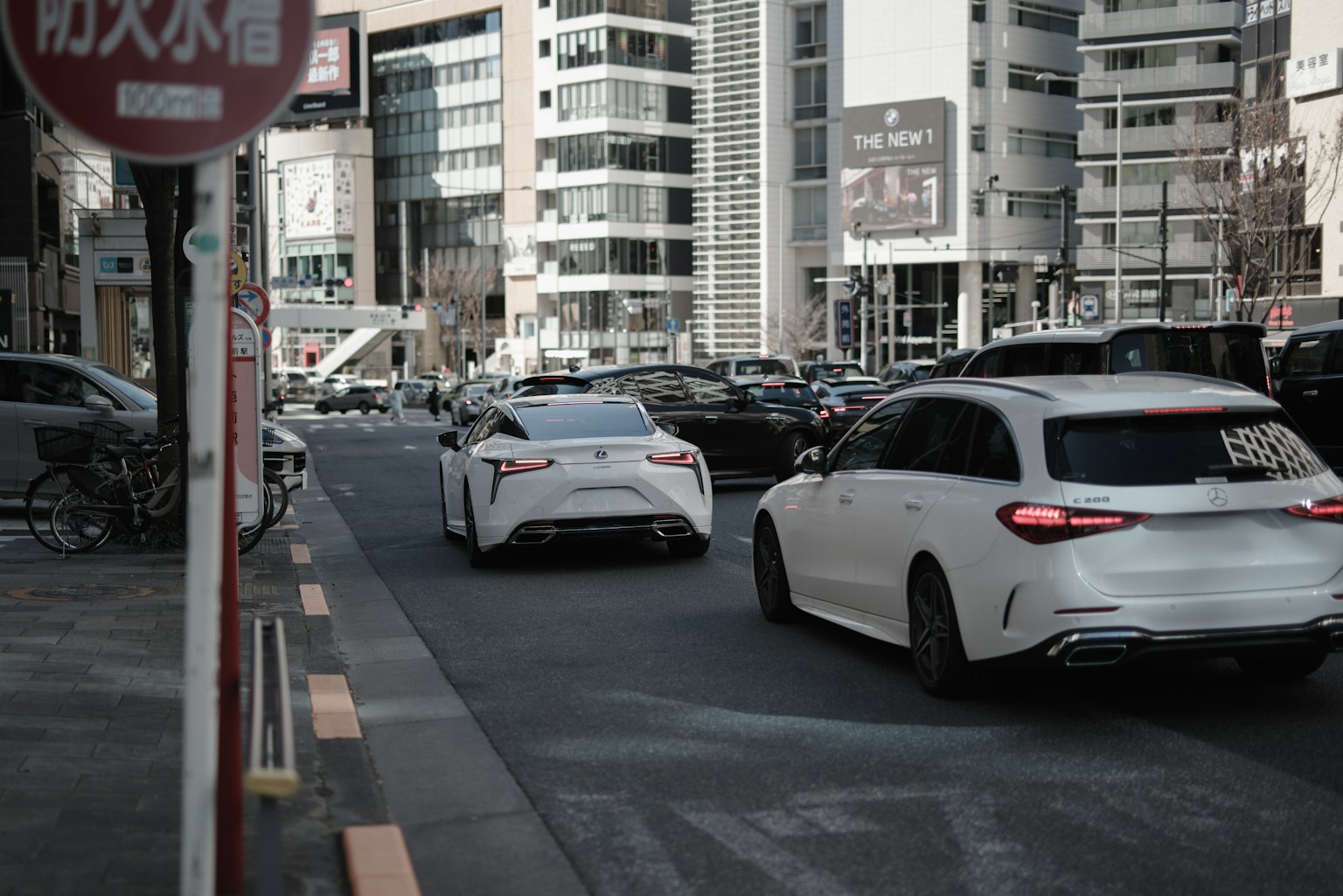 Auto bianche su una strada cittadina con edifici moderni