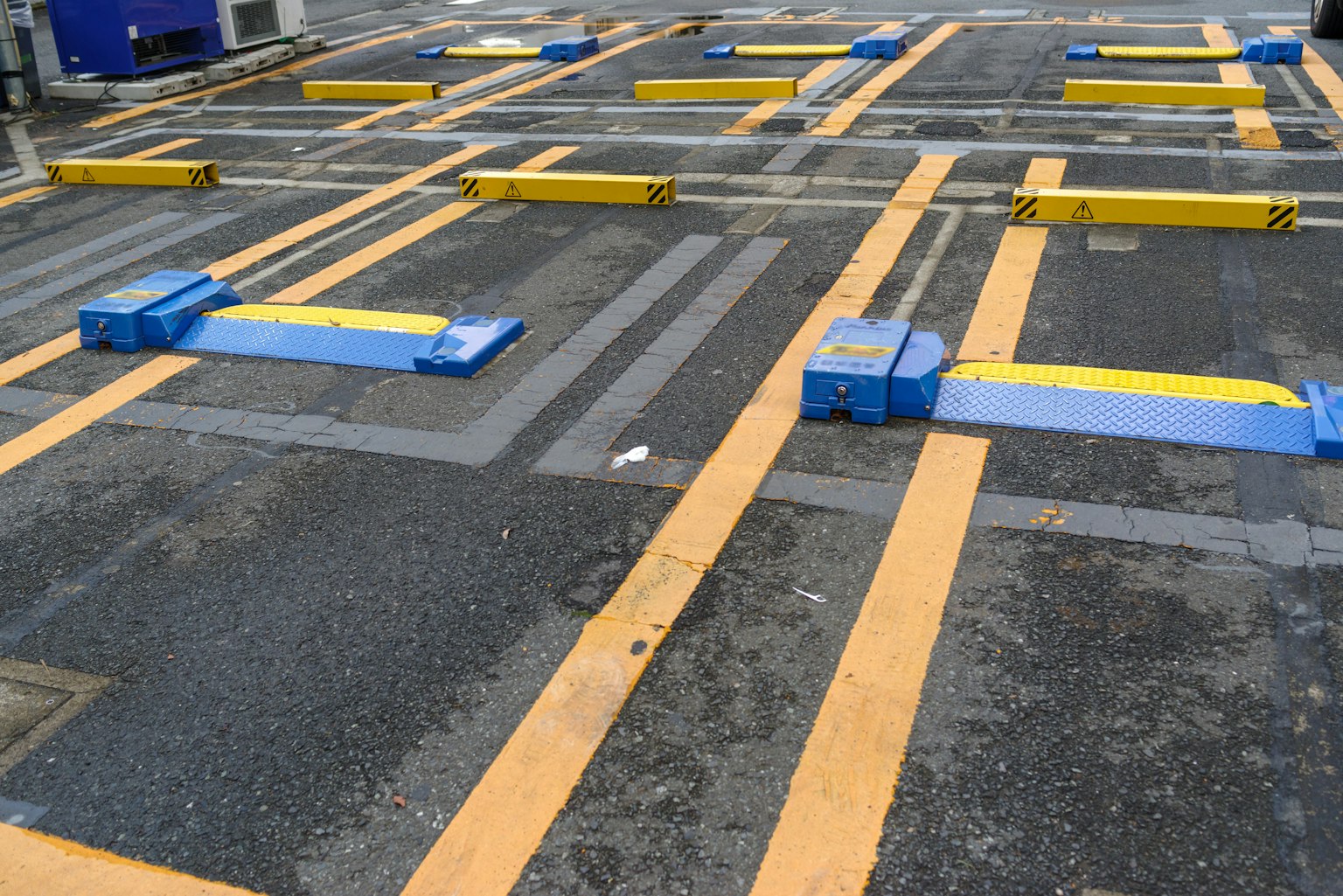 Parking lot surface with yellow and blue barriers