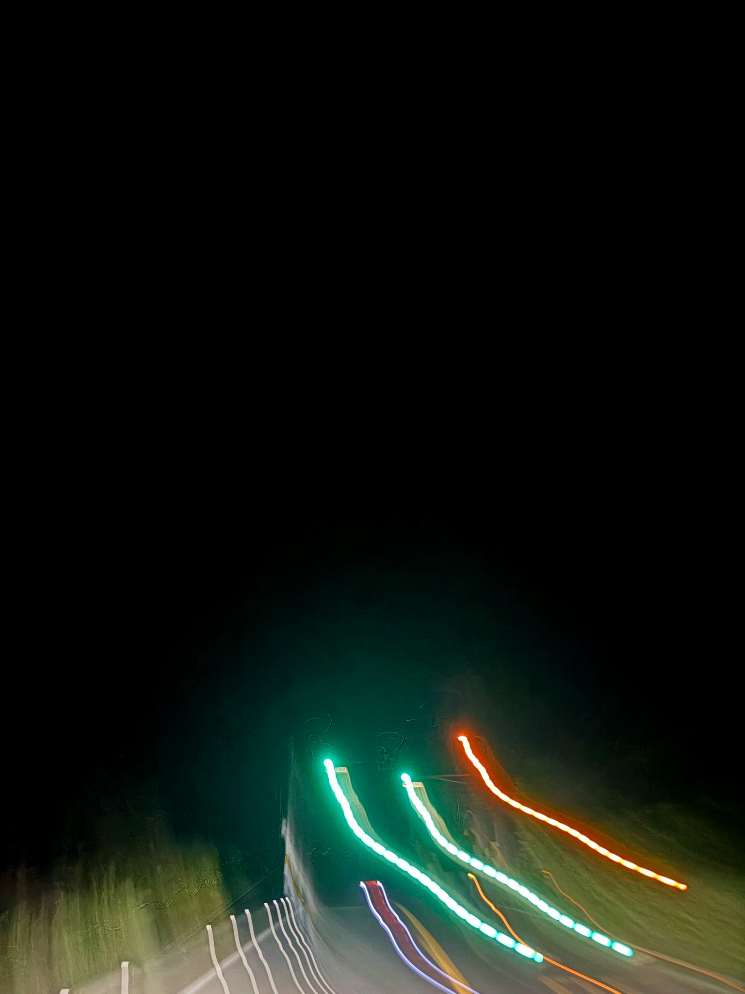 Image featuring blurred light streaks against a dark background