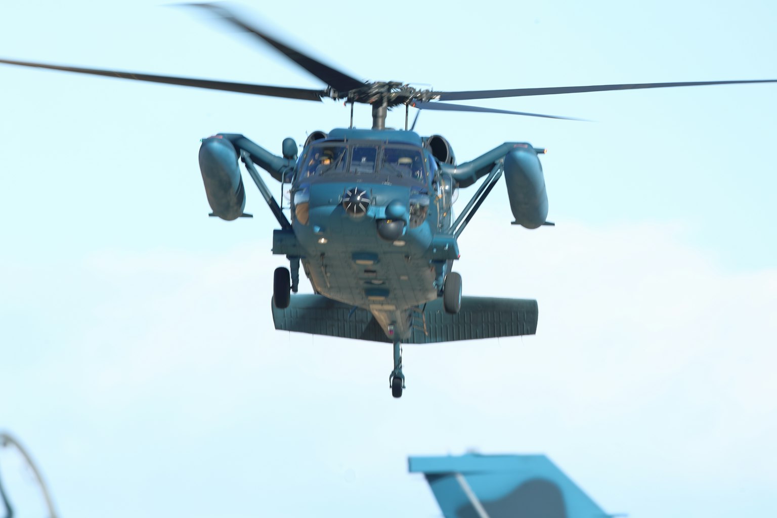 Blue helicopter hovering in the sky