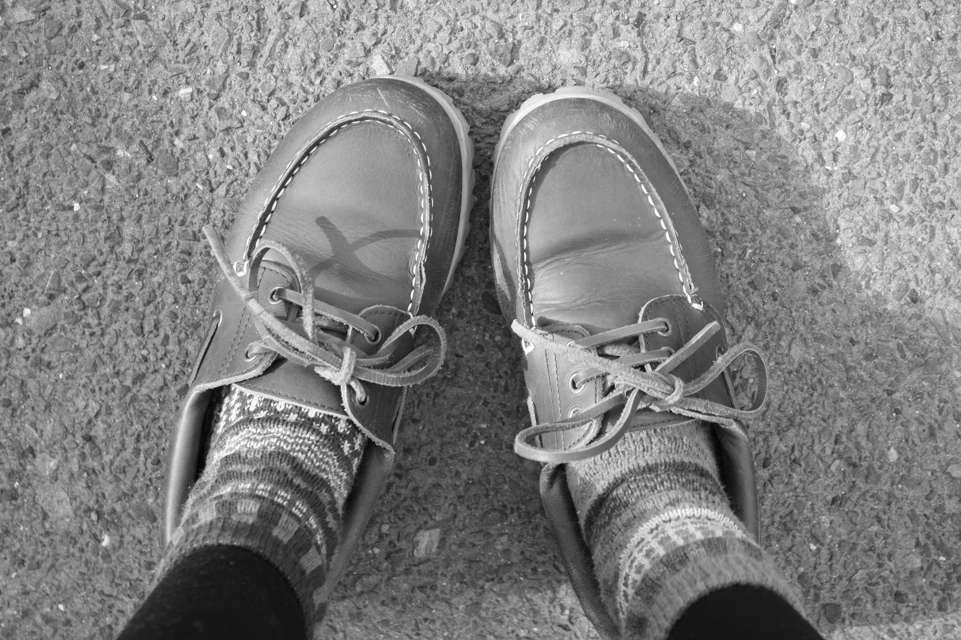 gray sneakers and patterned socks on pavement