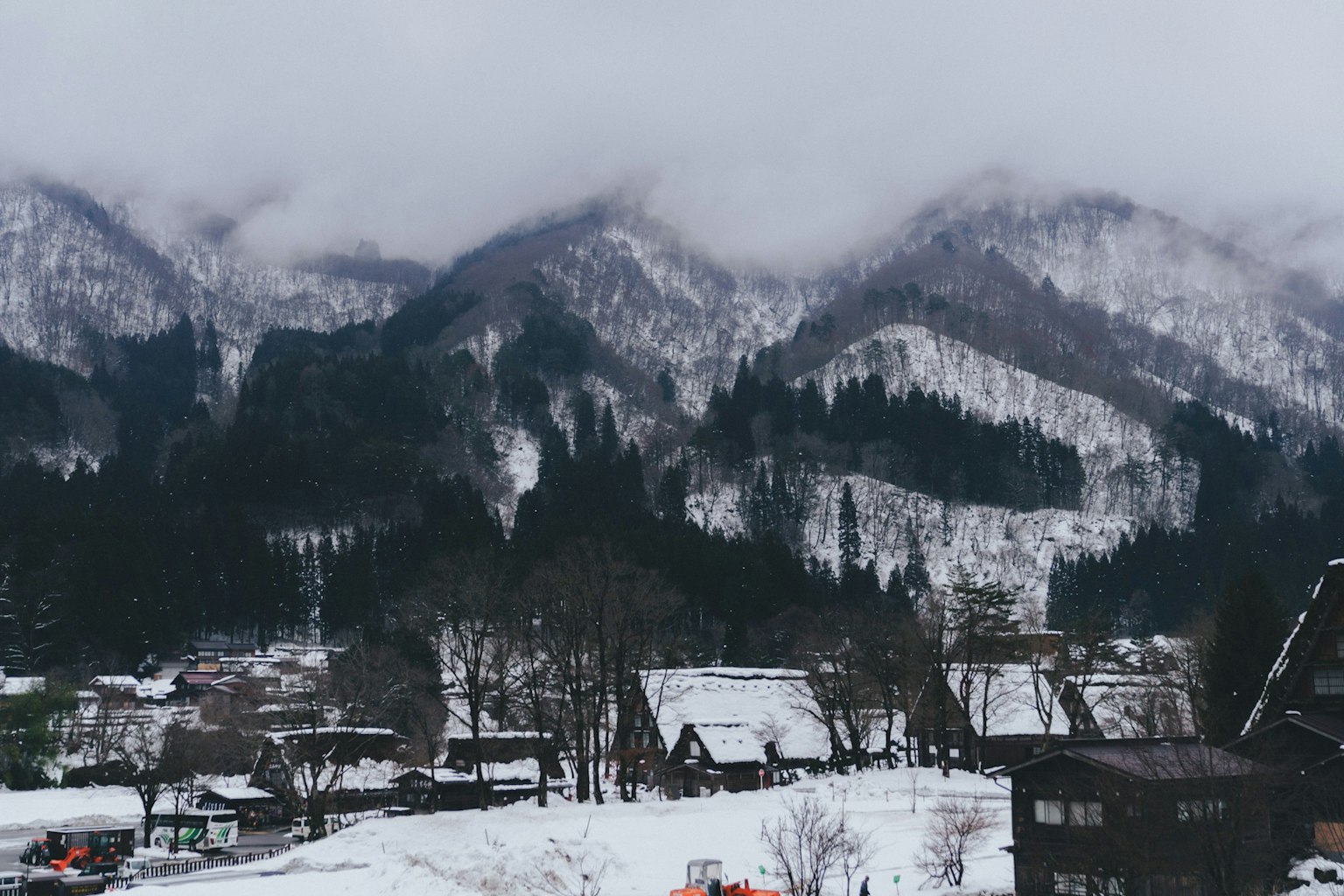 Snow-covered mountains and traditional houses in a winter landscape