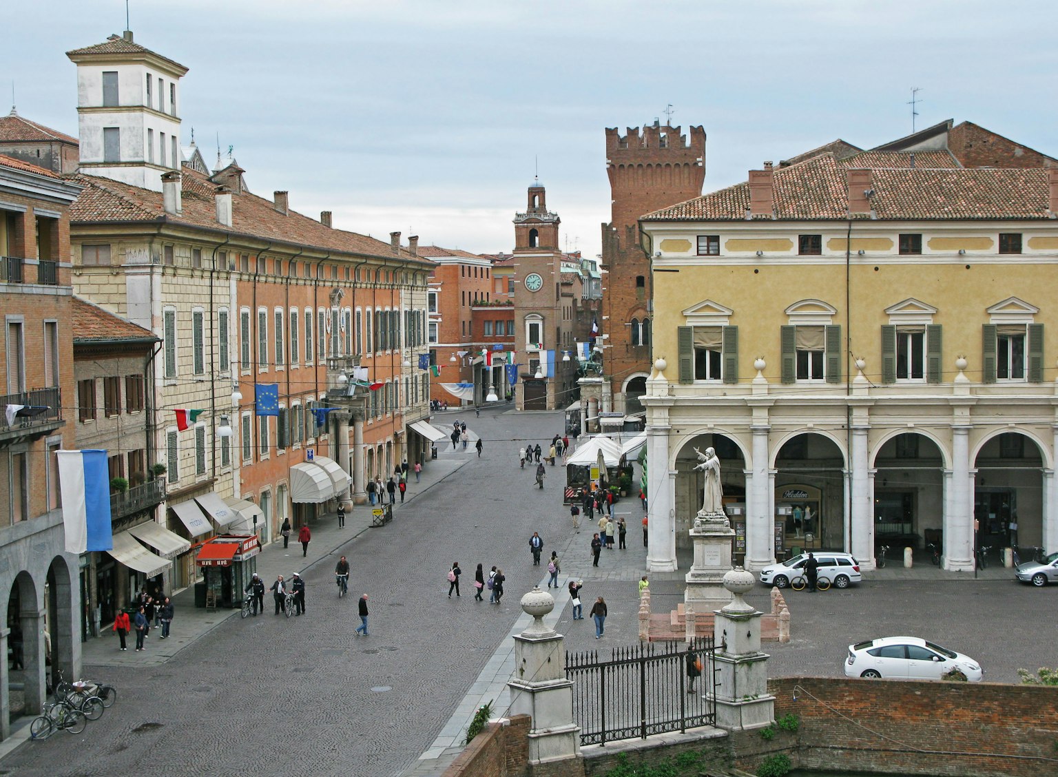 Italian street scene with historical buildings and a bustling square