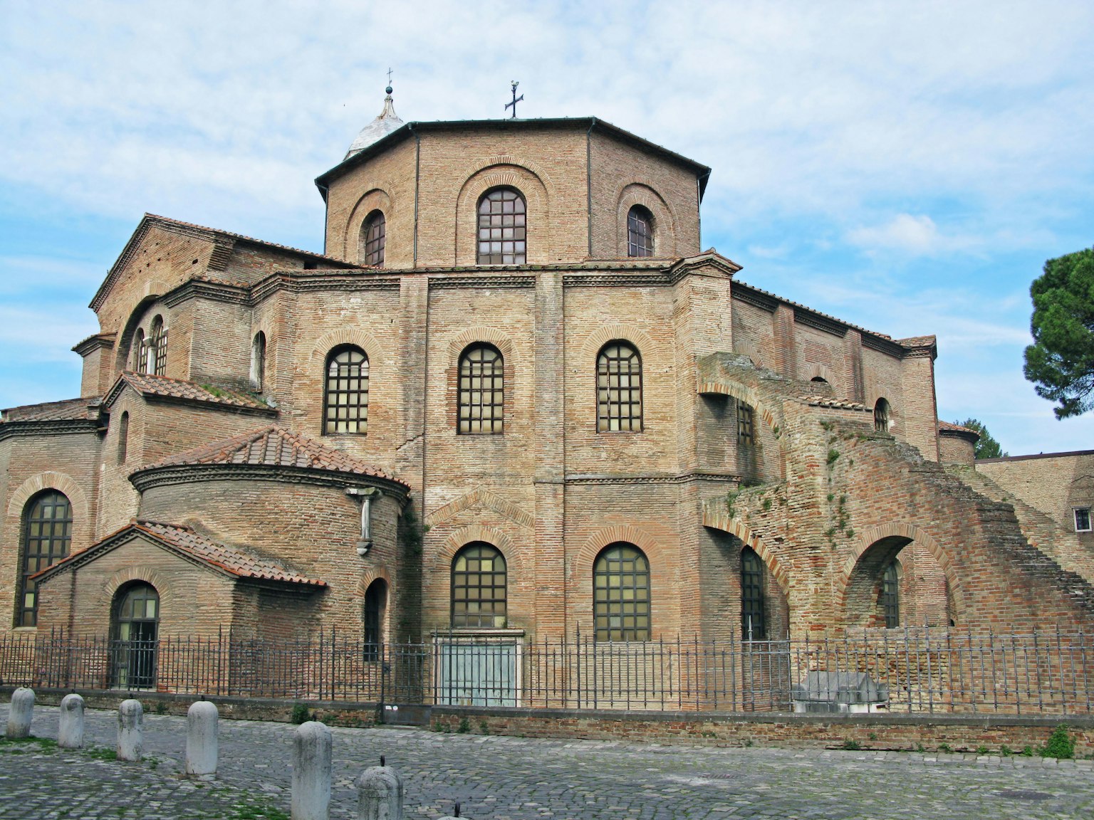 Exterior view of an ancient brick church featuring large windows