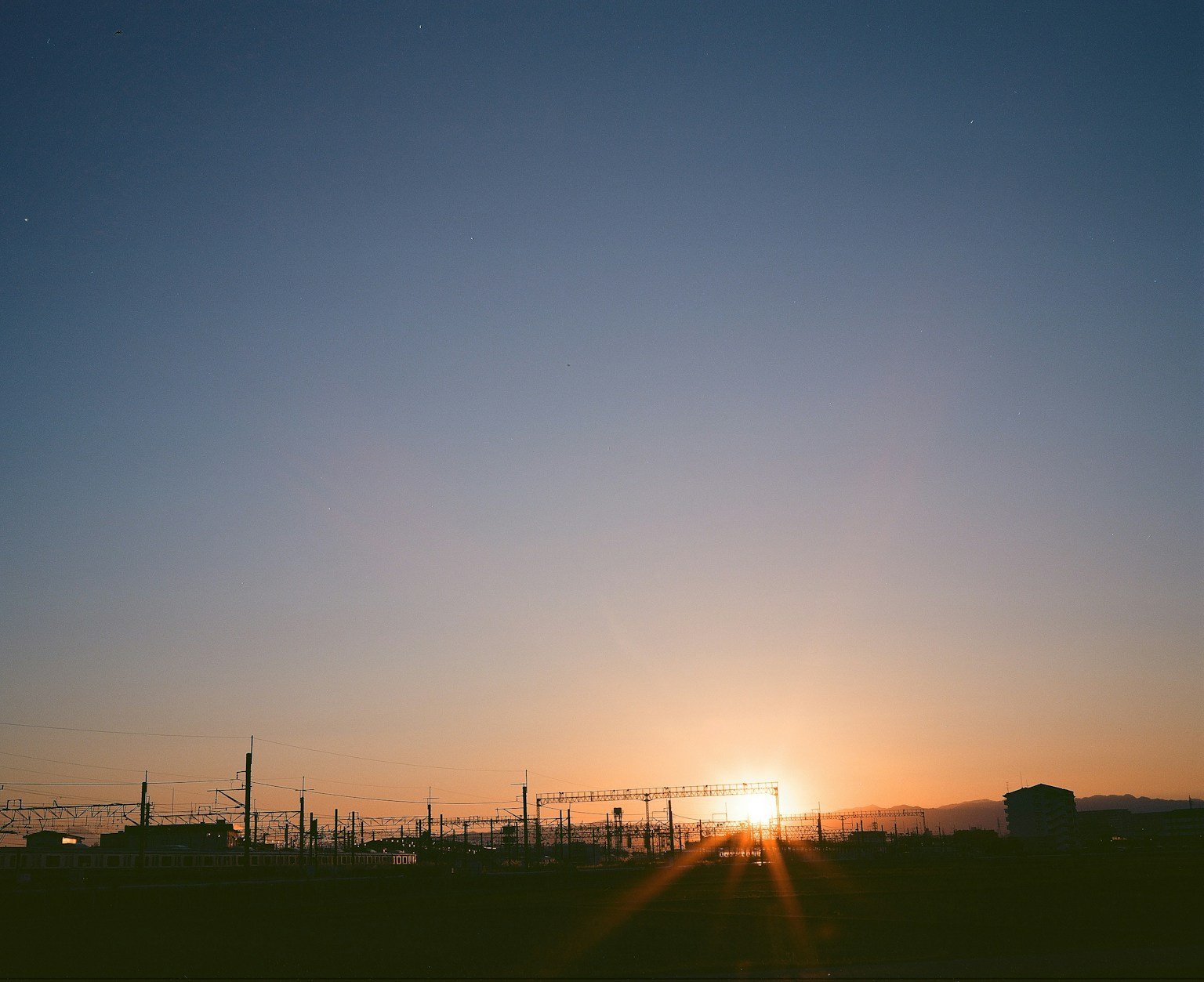 Landscape of a sunset with silhouetted train tracks