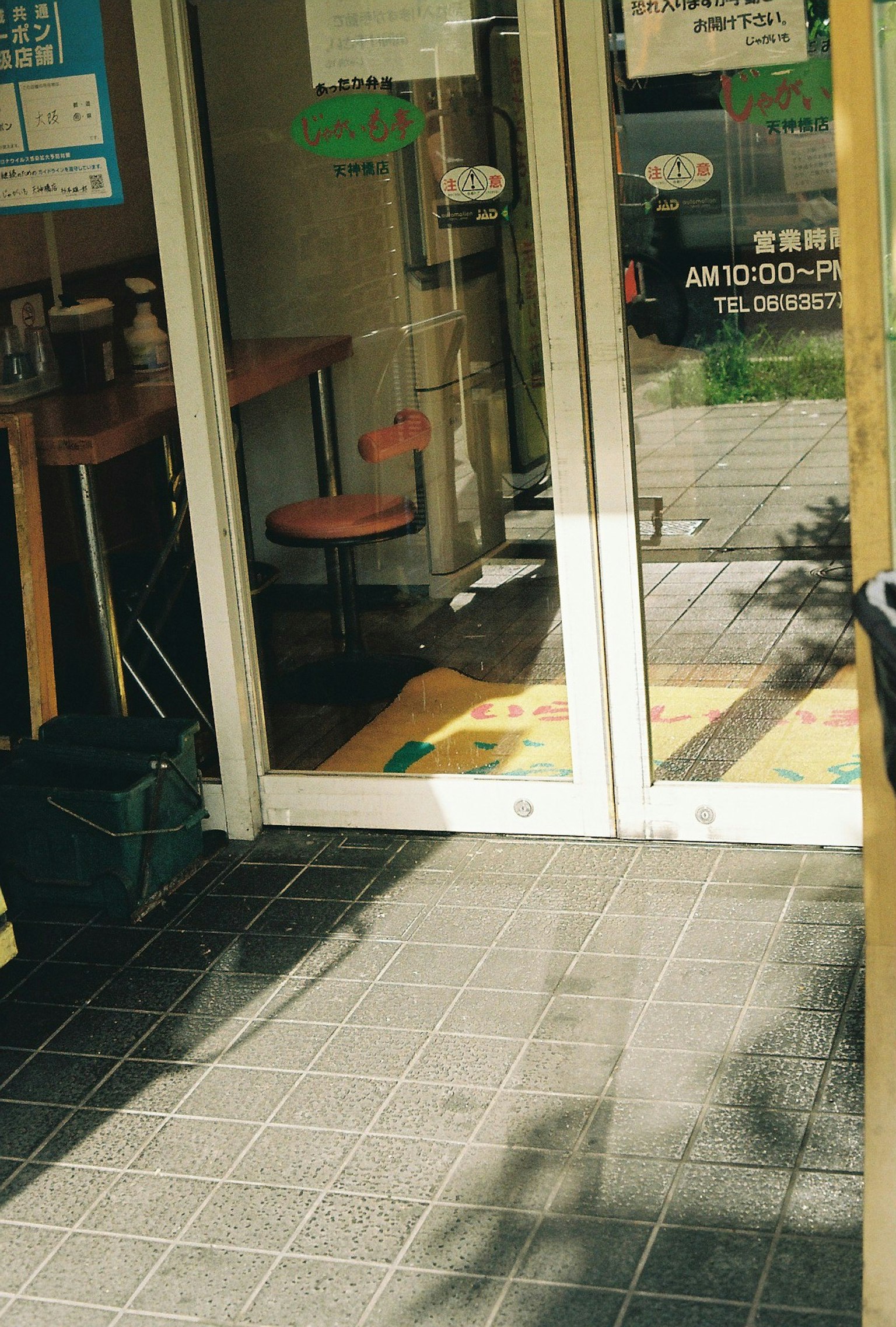 Foto pintu masuk toko dengan pintu terbuka dan interior terlihat