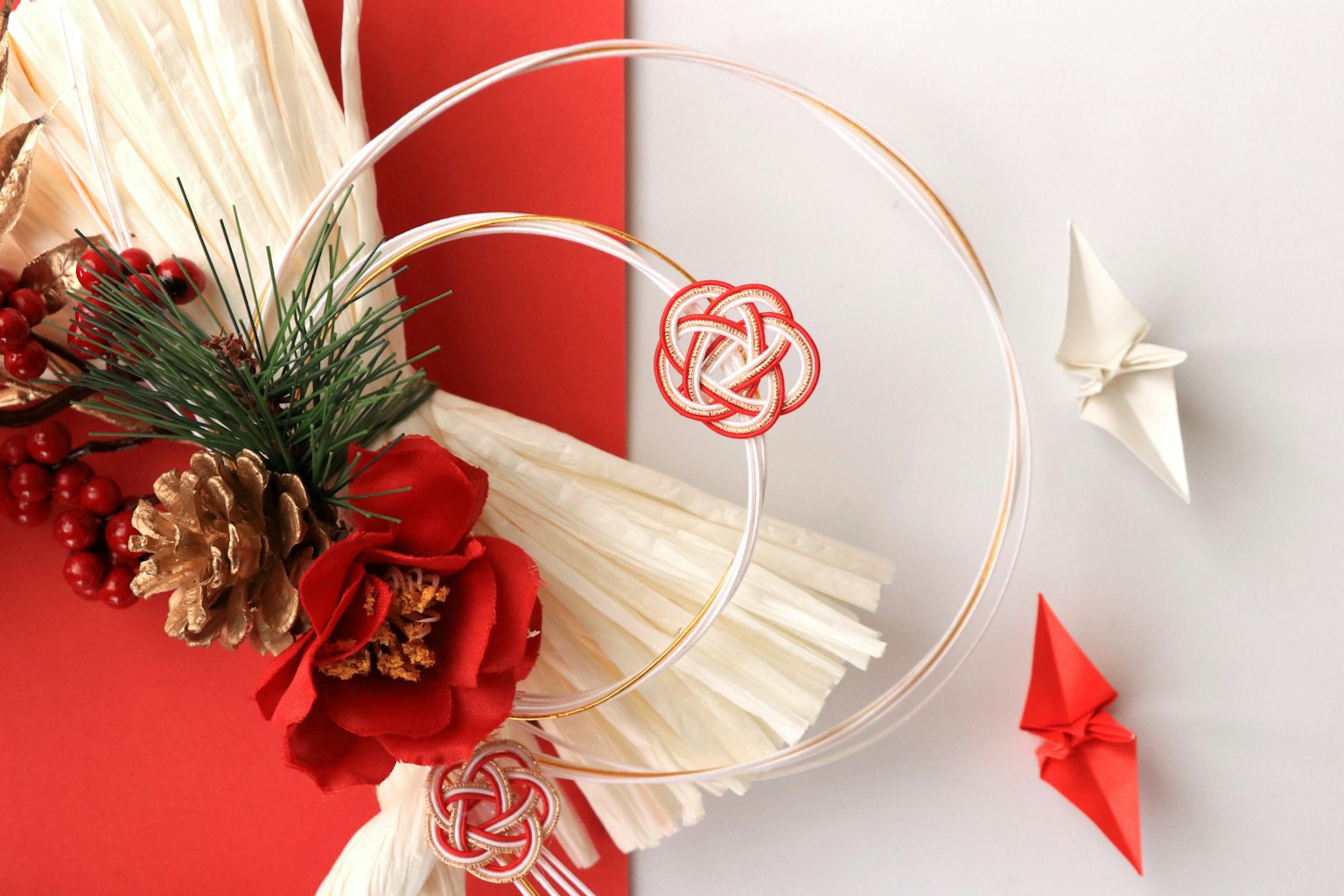 Traditional Japanese New Year decoration with origami on red and white background