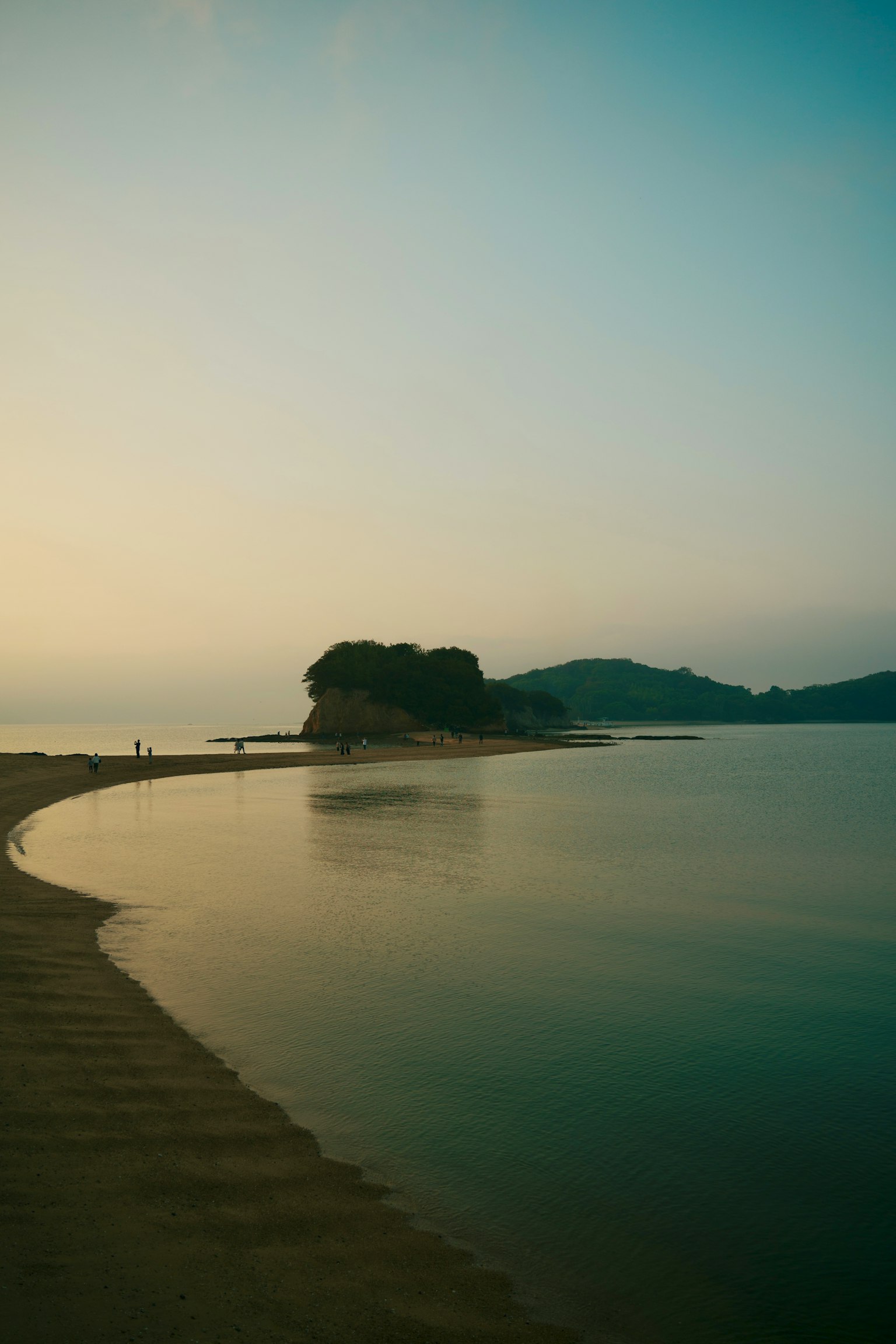 Serene seascape with an island at dusk